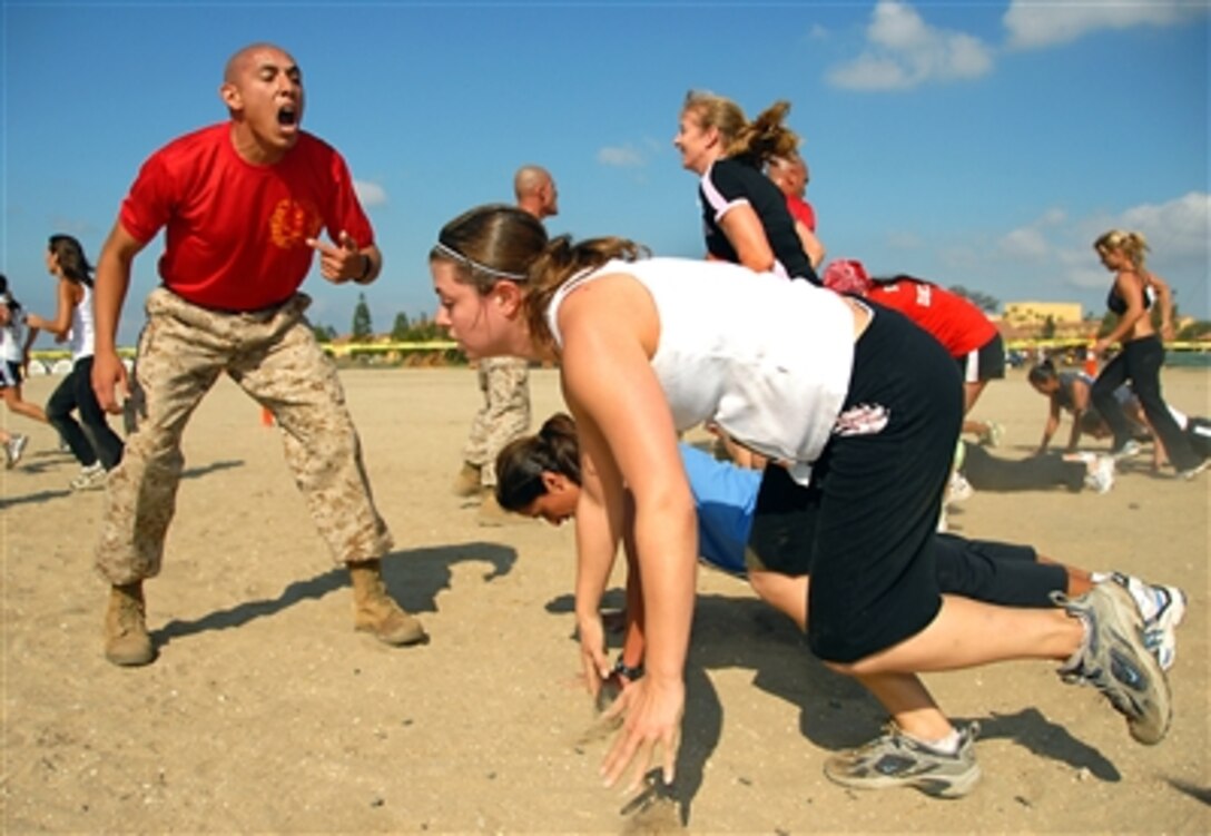 U.S. Marine Corps Sgt. Andrew Lopez, a drill instructor, provides encouragement to participants during the push-up section of the Boot Camp Challenge at Marine Corps Recruit Depot San Diego, Calif., Oct. 7, 2006. 