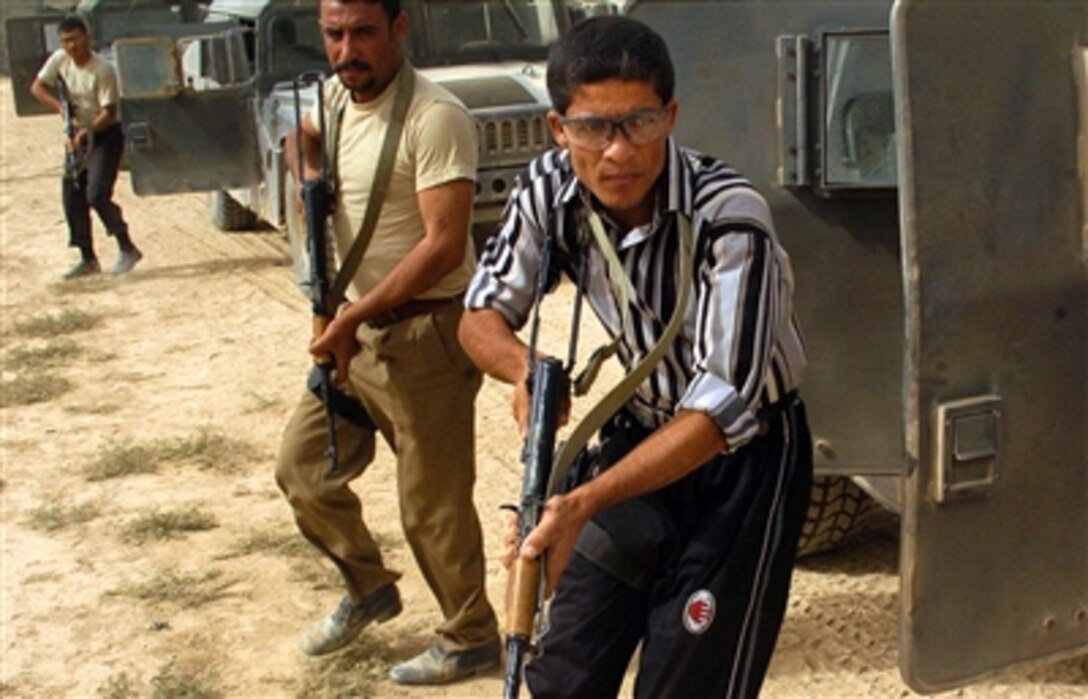 Iraqi policemen from Hawijah, Muhafazat Diyala province, Iraq, learn proper vehicle dismounting procedures as they take part in SWAT training at Forward Operating Base McHenry, Iraq, Oct. 3, 2006. 