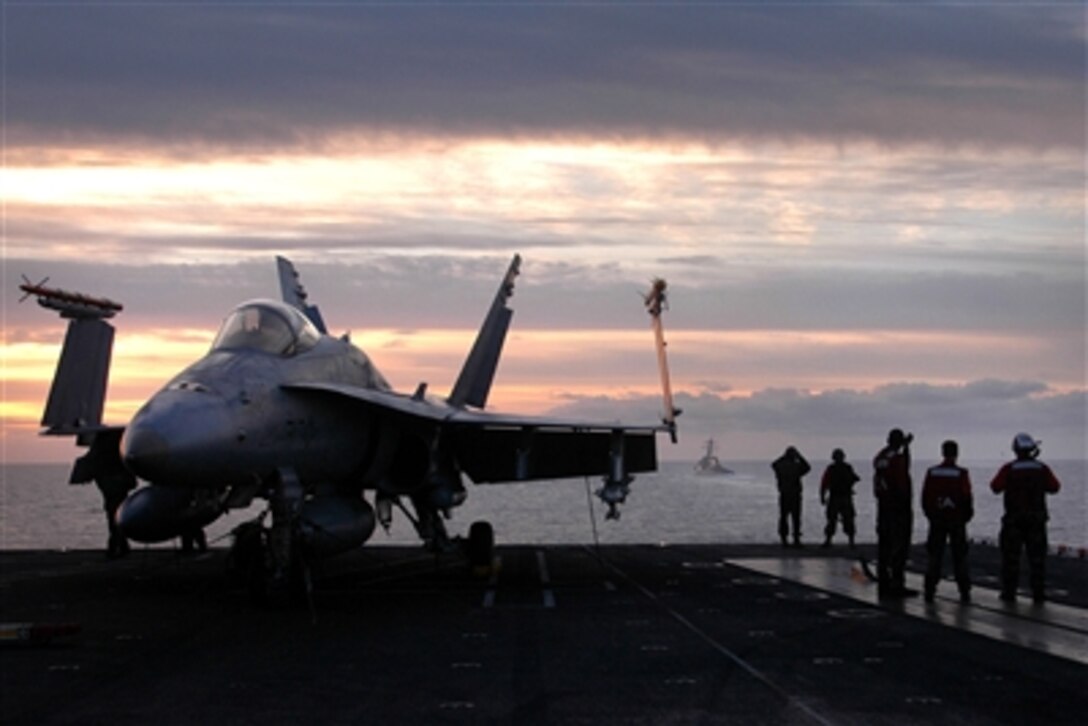 U.S. Navy sailors prepare for morning flight operations aboard the USS John C. Stennis, Oct. 4, 2006. Stennis and embarked Carrier Air Wing 9 are operating together for the first time during a composite training unit exercise. 