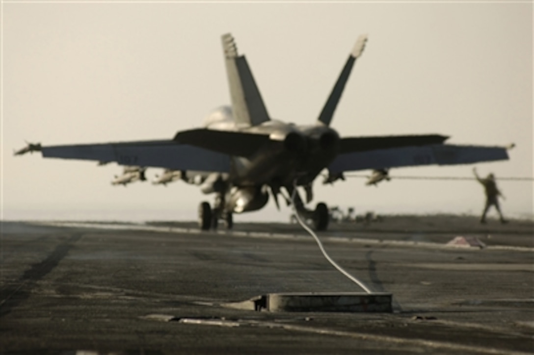 An F/A-18F Super Hornet aircraft hooks one of four arresting wires as it lands on the flight deck of the USS Enterprise (CVN 65) under way in the Arabian Sea on Sept. 26, 2006.  The Enterprise and embarked Carrier Air Wing 1 are on a six-month deployment in support of maritime security operations.  