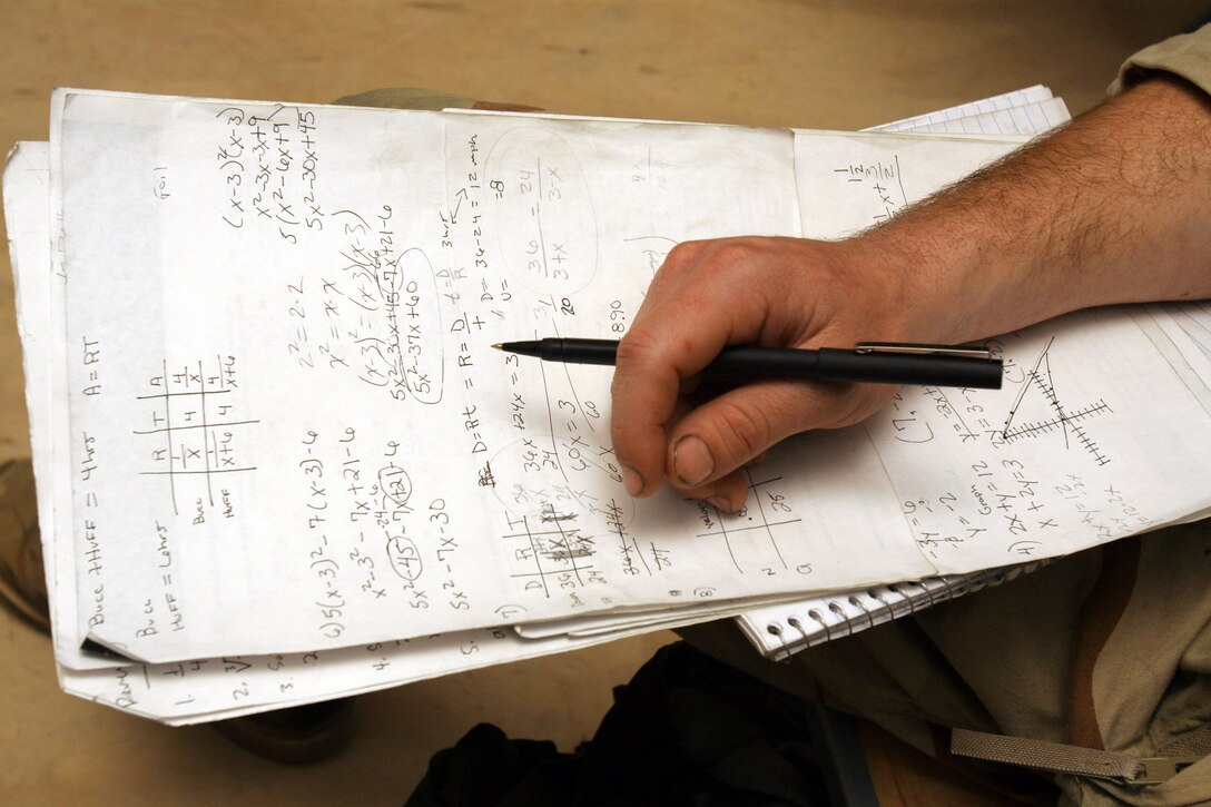 A scratch pad sits in front of a Marine studying algebra during his spare time at Al Asad, Iraq, Oct. 13.