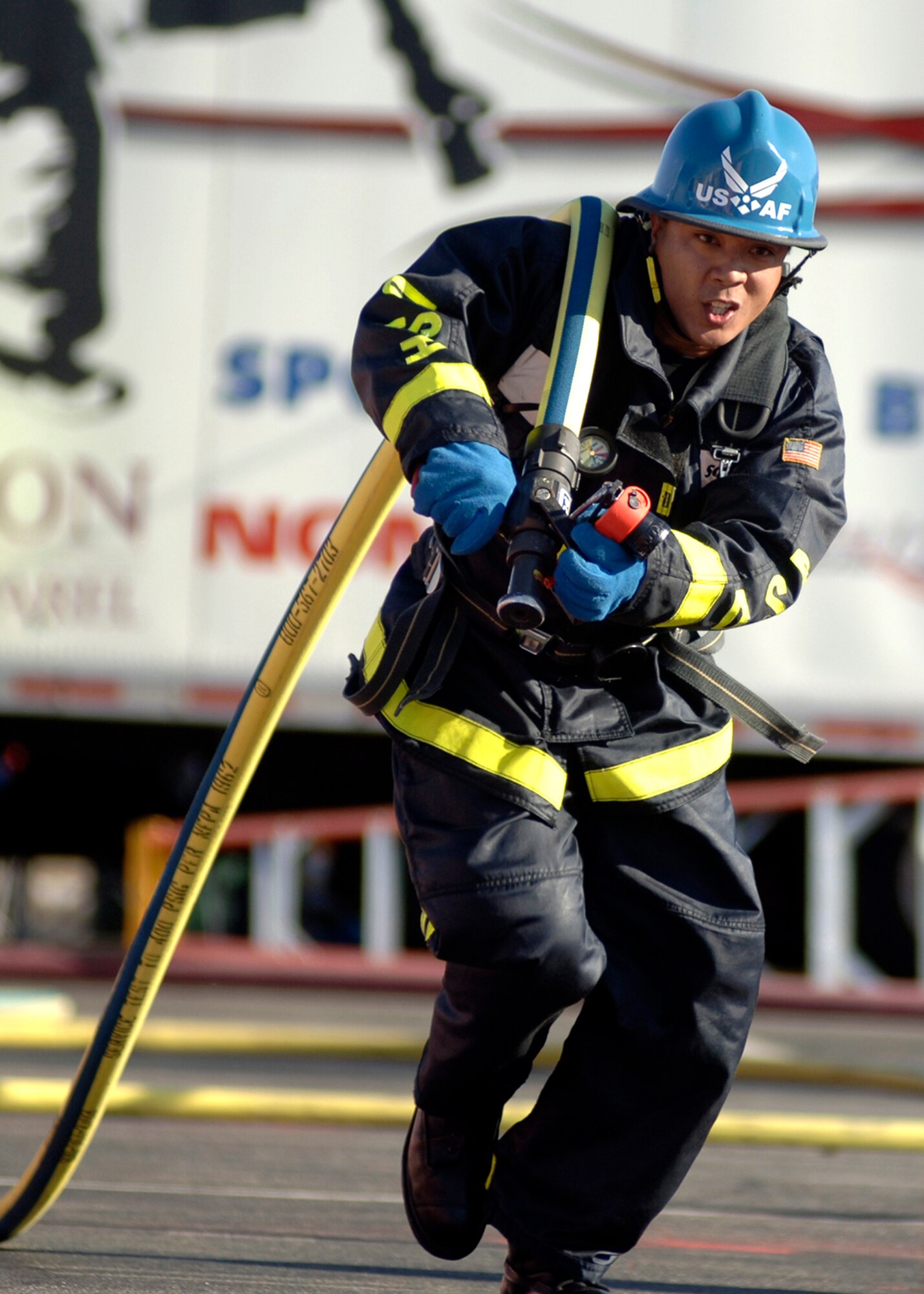 Aldrico Caragan, Team Travis, drags a fire hose 100 feet  during the Firefighter Combat Competition at Morrow, Ga., Oct. 13, 2006.  (U.S. Air Force photo/Tech. Sgt. Cecilio M. Ricardo Jr.)
