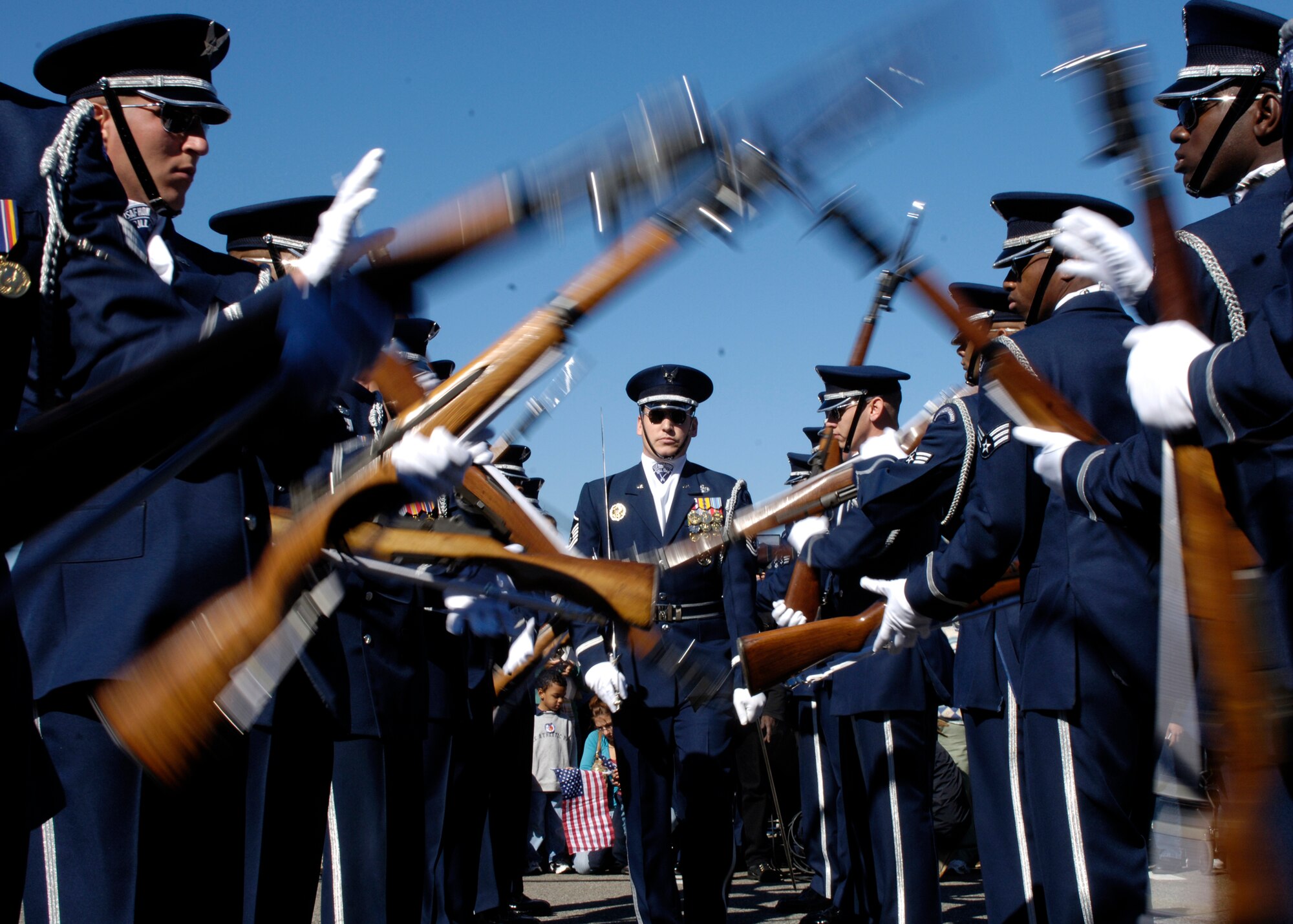 Members of the United States Air Force Drill Team perform during the Air Force open house at the Pentagon on Saturday, Oct. 14, 2006. The open house is running in conjunction with the official ceremony to dedicate the Air Force Memorial. President George W. Bush will join Senior Defense Dept. and Air Force officials in a ceremony to present the memorial to the Nation. Desiged by the late James Ingo Freed the memorial with its three soaring spires inspired by the U.S. Air Force Thunderbirds bomb burst manuever, pays tribute to and honors the patriotic men and women of the U.S. Air Force and its predeccessor organizations. An open house will run near the Pentagon in conjunction with the dedication ceremony which will feature performances by the U.S. Air Force Band, the U.S. Air Force Honor Guard drill team, and will culminate with a concert featuring country music performer LeeAnn Womack. (U.S. Air Force photo/Tech. Sgt. Rebecca F. Corey) 
