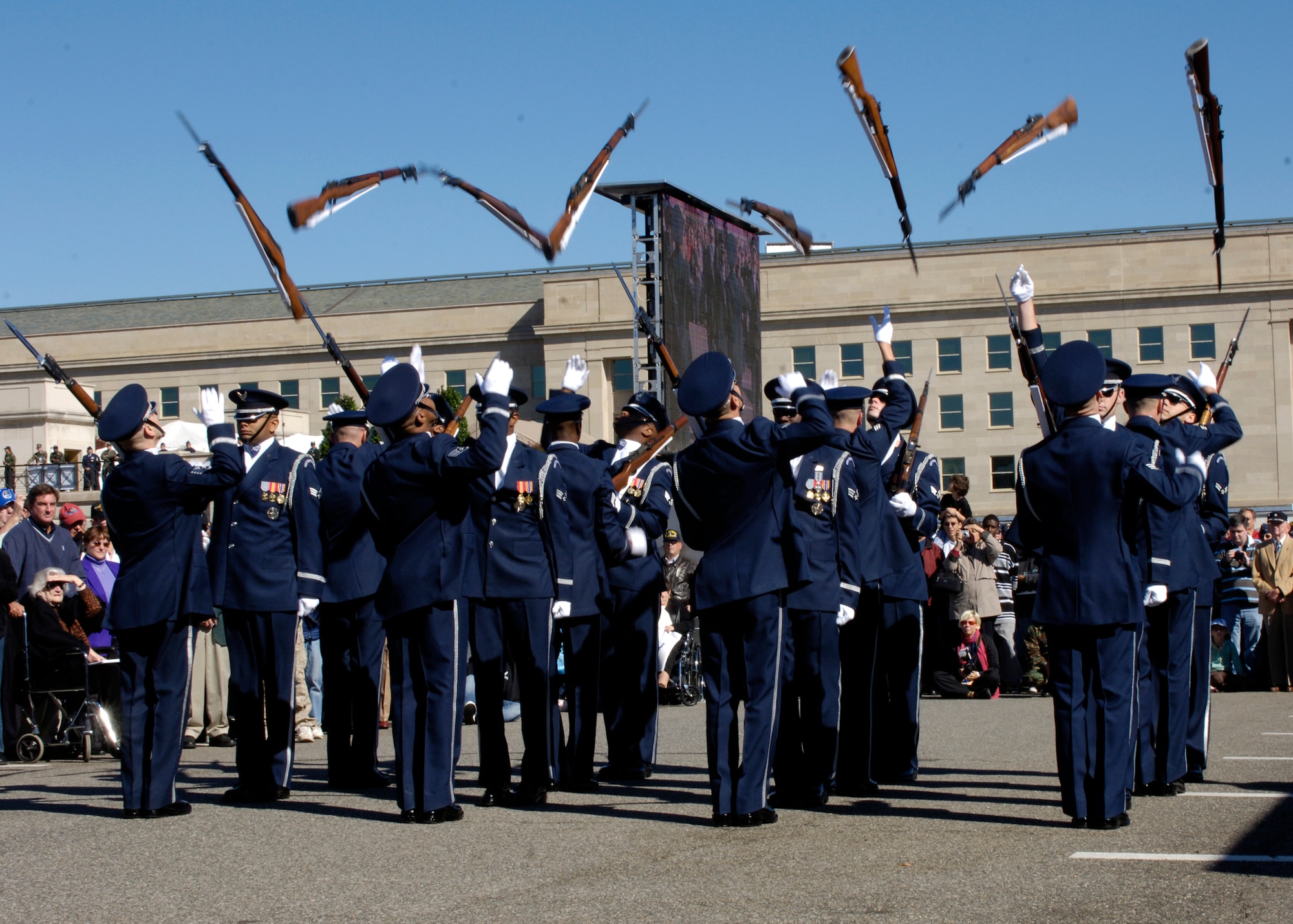 Members of the United States Air Force Drill Team perform during the Air Force open house at the Pentagon on Saturday, Oct. 14, 2006. The open house is running in conjunction with the official ceremony to dedicate the Air Force Memorial. President George W. Bush will join Senior Defense Dept. and Air Force officials in a ceremony to present the memorial to the Nation. Desiged by the late James Ingo Freed the memorial with its three soaring spires inspired by the U.S. Air Force Thunderbirds bomb burst manuever, pays tribute to and honors the patriotic men and women of the U.S. Air Force and its predeccessor organizations. An open house will run near the Pentagon in conjunction with the dedication ceremony which will feature performances by the U.S. Air Force Band, the U.S. Air Force Honor Guard drill team, and will culminate with a concert featuring country music performer LeeAnn Womack. (U.S. Air Force photo/Tech. Sgt. Rebecca F. Corey) 