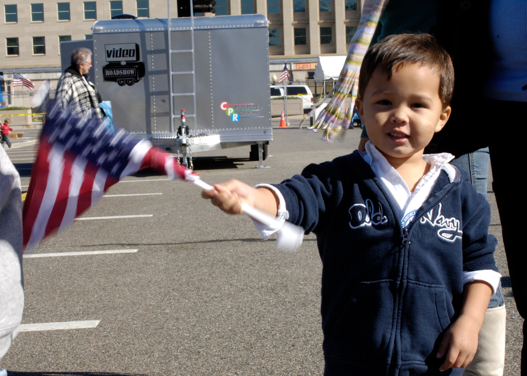 B. Hayden Braham shows his enthusiasm during a performance by members of the United States Air Force Drill Team during the Air Force open house at the Pentagon on Saturday, Oct. 14, 2006. The open house is running in conjunction with the official ceremony to dedicate the Air Force Memorial. President George W. Bush will join Senior Defense Dept. and Air Force officials in a ceremony to present the memorial to the Nation. Desiged by the late James Ingo Freed the memorial with its three soaring spires inspired by the U.S. Air Force Thunderbirds bomb burst manuever, pays tribute to and honors the patriotic men and women of the U.S. Air Force and its predeccessor organizations. An open house will run near the Pentagon in conjunction with the dedication ceremony which will feature performances by the U.S. Air Force Band, the U.S. Air Force Honor Guard drill team, and will culminate with a concert featuring country music performer LeeAnn Womack. (U.S. Air Force photo/Tech. Sgt. Rebecca F. Corey) 