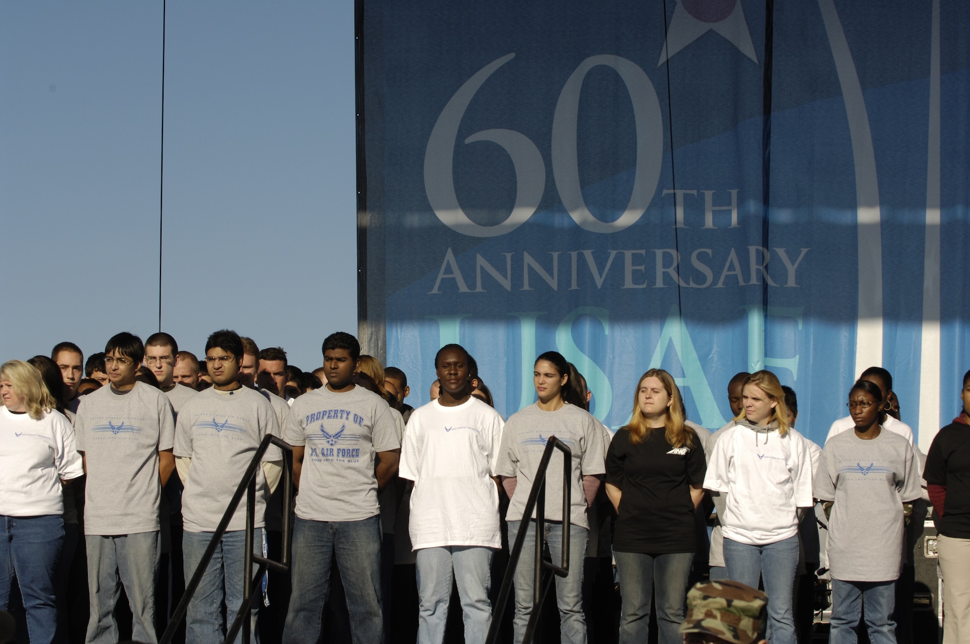 Ninety young men and women wait to become inducted as the newest members of U.S. Air Force by Air Force Chief of Staff Gen. T. Michael Moseley on Saturday, Oct. 14, 2006. The induction ceremony was conducted during open house activities at the Pentagon prior to the official dedication ceremony of the Air Force Memorial. President George W. Bush will join Senior Defense Dept. and Air Force officials in a ceremony to present the memorial to the Nation. Desiged by the late James Ingo Freed the memorial with its three soaring spires inspired by the U.S. Air Force Thunderbirds bomb burst manuever, pays tribute to and honors the patriotic men and women of the U.S. Air Force and its predeccessor organizations. An open house will run near the Pentagon in conjunction with the dedication ceremony which will feature performances by the U.S. Air Force Band, the U.S. Air Force Honor Guard drill team, and will culminate with a concert featuring country music performer LeeAnn Womack. (U.S. Air Force photo/Airman 1st Class Rusti M. Caraker) 