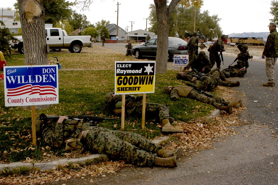 Mock casualties from Co. F, 2nd Bn., 23rd Marine Regiment, lay "dead" on the lawn of Mike Berg, head emergency medical technician for Milford, Utah. The company and 6th Motor Transport Battalion used the town in a combined exercise Oct. 12-15.