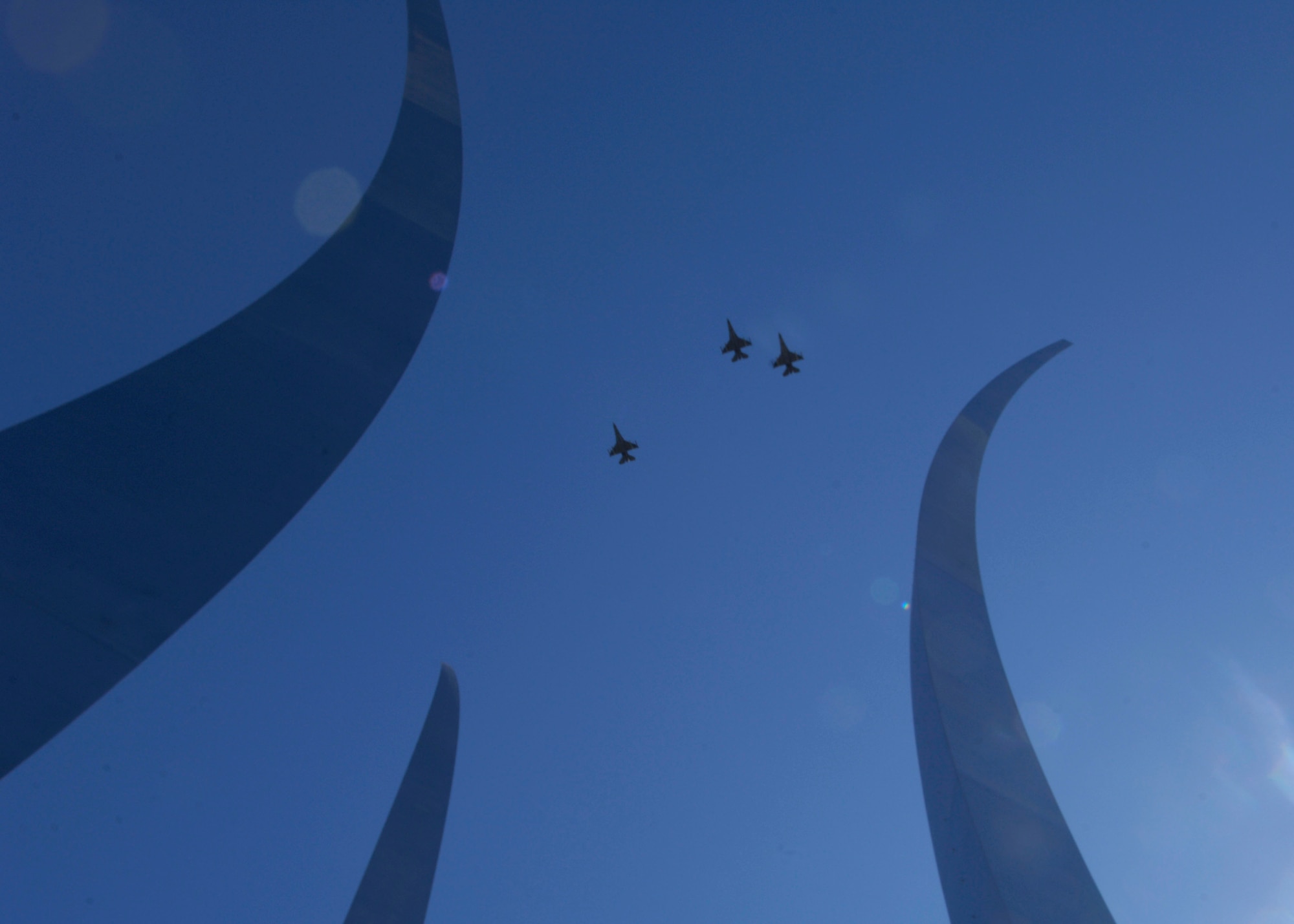 The Air Force Thunderbirds flew over the new Air Force Memorial in the "Missing Man" formation at the conclusion of the wreath dedication ceremony led by Secretary of the Air Force Michael W. Wynne, whom with the help of Air Force Chief of Staff T. Michael Mosely and Air Force Memorial Foudation Chairman Ross Perot, Jr., Chief Master Sergeant of the Air Force Rodney J. McKinley and former Secretaries of the Air Force, Chief of Staffs and Chief Master Sergeants of the Air Force  officially closed the Air Force Memorial commemoration weekend with a wreath laying ceremony in Arlington, Va., Oct. 15, 2006. On behalf of all American citizens President George W. Bush accepted the Air Force Memorial from Air Force Memorial Foundation Chairman Ross Perot Jr. during the previous day's dedication ceremony at the base of the Air Force Memorial that overlooks the Pentagon.  Designed by the late James Ingo Freed the memorial with its three soaring spires inspired by the U.S. Air Force Thunderbirds bomb burst manuever, pays tribute to and honors the patriotic men and women of the U.S. Air Force and its predeccessor organizations. An open house was held near the Pentagon in conjunction with the dedication ceremony which featured performances by the U.S. Air Force Band, the U.S. Air Force Honor Guard drill team, and culminated with a concert featuring country music performer LeeAnn Womack. (U.S. Air Force photo/Tech. Sgt. Cohen Young) 