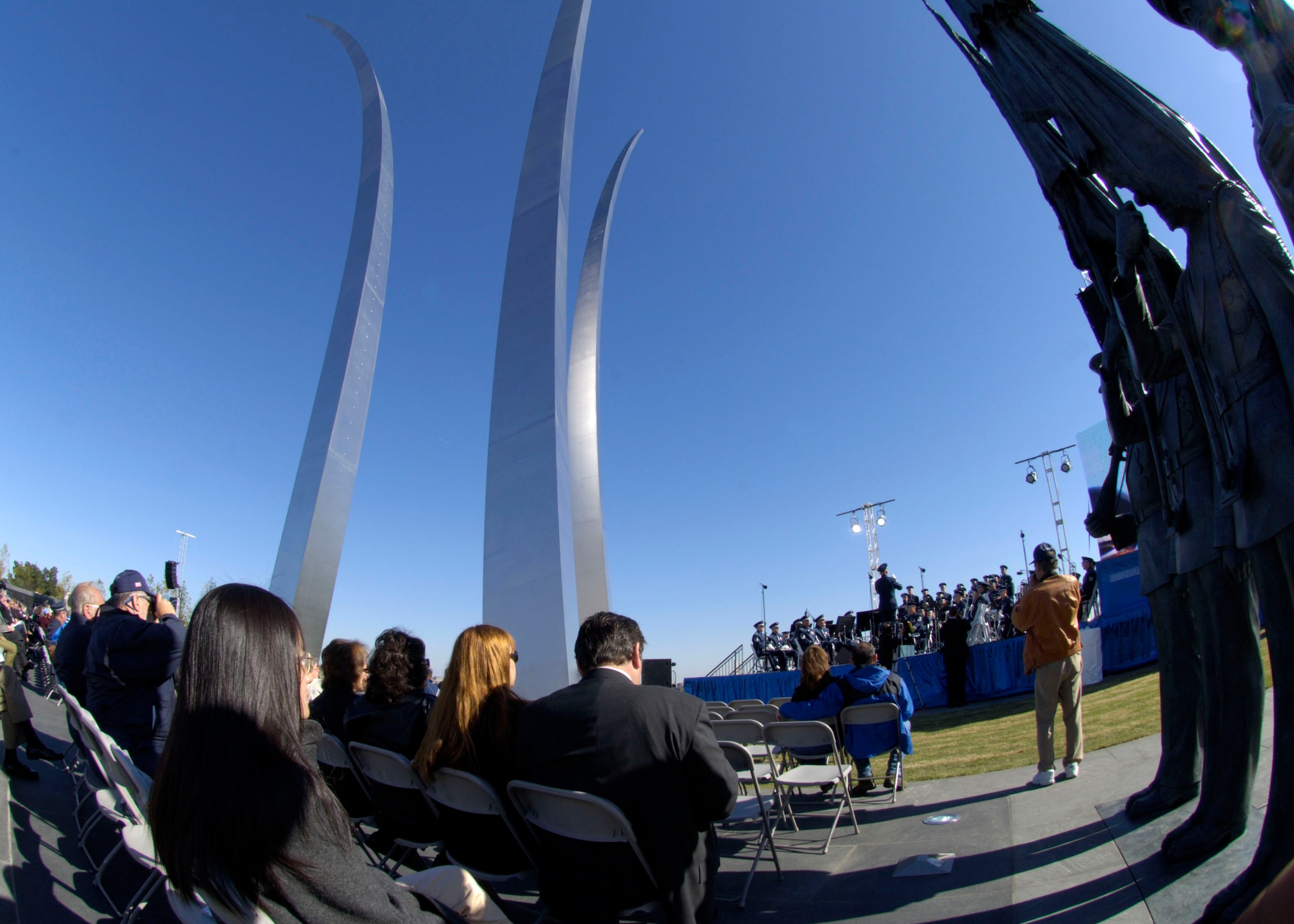 Hundreds gathered at the base of the new Air Force Memorial  as Secretary of the Air Force Michael W. Wynne officially closed the Air Force Memorial commemoration with a wreath laying ceremony in Arlington, Va., Oct. 15, 2006. On behalf of all American citizens President George W. Bush accepted the Air Force Memorial from Air Force Memorial Foundation Chairman Ross Perot Jr. during the previous day's dedication ceremony at the base of the Air Force Memorial that overlooks the Pentagon.  Designed by the late James Ingo Freed the memorial with its three soaring spires inspired by the U.S. Air Force Thunderbirds bomb burst manuever, pays tribute to and honors the patriotic men and women of the U.S. Air Force and its predeccessor organizations. An open house was held near the Pentagon in conjunction with the dedication ceremony which featured performances by the U.S. Air Force Band, the U.S. Air Force Honor Guard drill team, and culminated with a concert featuring country music performer LeeAnn Womack. (U.S. Air Force photo/Tech. Sgt. Cohen Young) 