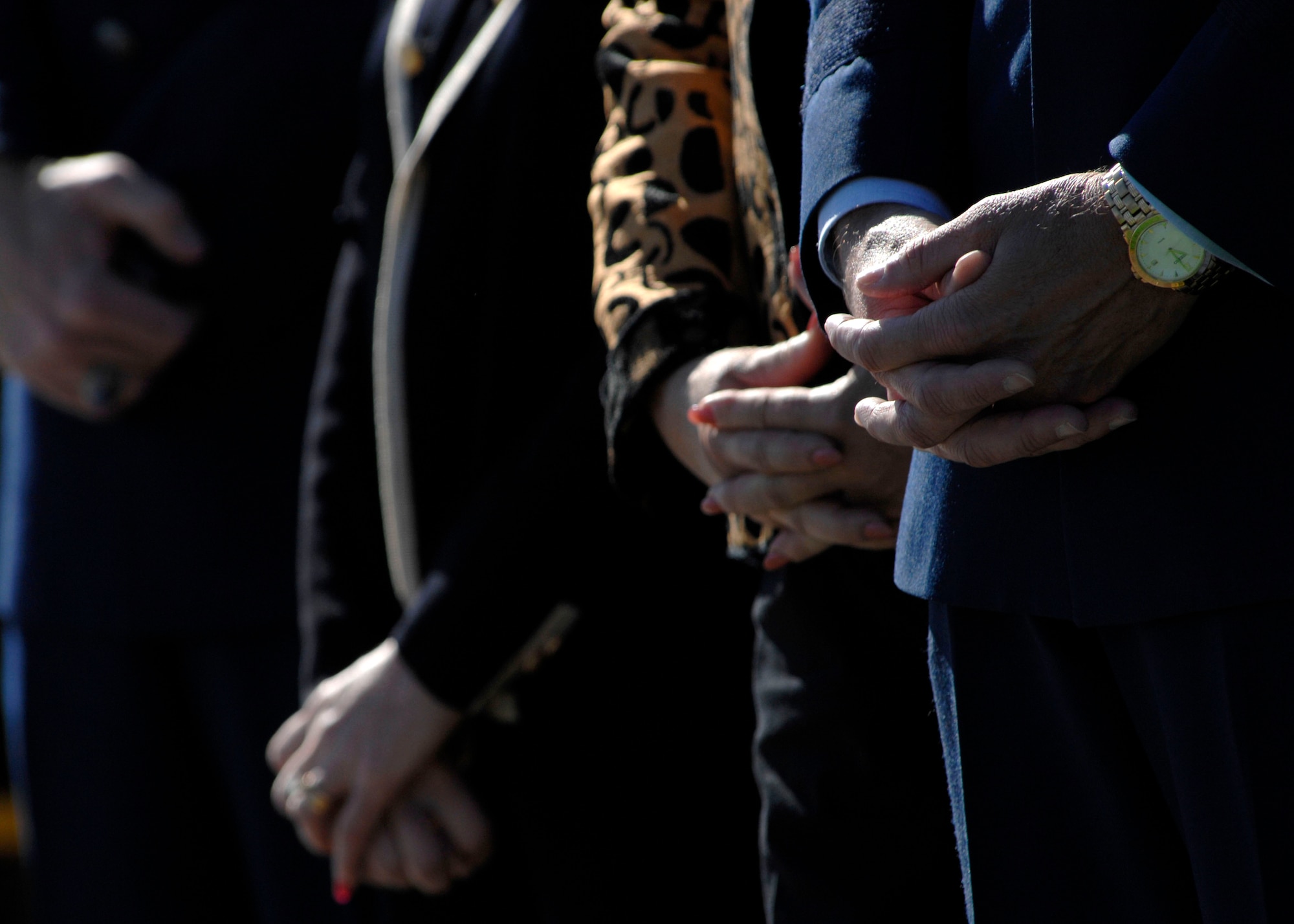 Heads are bowed and hands are crossed during the opening prayer of the Wreath Ceremony held at the base of the new Air Force Memorial in Arlington, Va., Oct. 15, 2006. Secretary of the Air Force Michael W. Wynne officially closed the Air Force Memorial commemoration by leading the wreath laying ceremony.  On behalf of all American citizens President George W. Bush accepted the Air Force Memorial from Air Force Memorial Foundation Chairman Ross Perot Jr. during the previous day's dedication ceremony at the base of the Air Force Memorial that overlooks the Pentagon.  Designed by the late James Ingo Freed the memorial with its three soaring spires inspired by the U.S. Air Force Thunderbirds bomb burst manuever, pays tribute to and honors the patriotic men and women of the U.S. Air Force and its predeccessor organizations. An open house was held near the Pentagon in conjunction with the dedication ceremony which featured performances by the U.S. Air Force Band, the U.S. Air Force Honor Guard drill team, and culminated with a concert featuring country music performer LeeAnn Womack. (U.S. Air Force photo/Tech. Sgt. Cohen Young)
