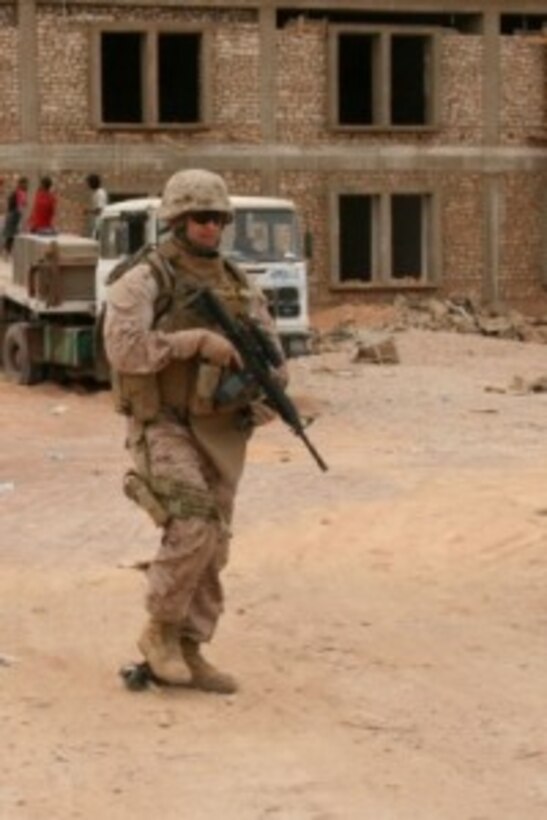 Sgt. Joan A. Ferreira (right), a 24-year-old team leader with Task Force Military Police, Multi-National Force-West, leads his Marines on patrol through a construction site near the Port of Trebil on Oct. 15. Ferreira is a New York City police officer and Individual Ready Reservist currently on one-year mobilization order