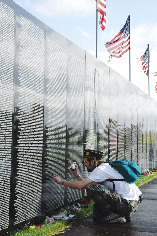 Visitors, veterans and family members observe the traveling Vietnam Wall in Pierre Saturday after the dedication ceremony. "The Wall" is a replica of the Vietnam Veterans National Memorial located in Washington, D.C.
