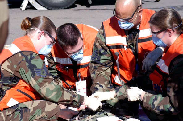 (Left to right) Staff Sgt. Amanda Elmandorf, Staff Sgt. Helder Raposo, Master Sgt. Keith Wright and Senior Airman Elizabeth Thomason, tend to a “victim” during the Operational Readiness Inspection Oct. 11. The scenario involved an explosion at the fitness center, and the inspection was to see how base personnel responded.
The four are from the 21st Aerospace Medicine Squadron.
(U.S. Air Force photo by Joe Fischer)
