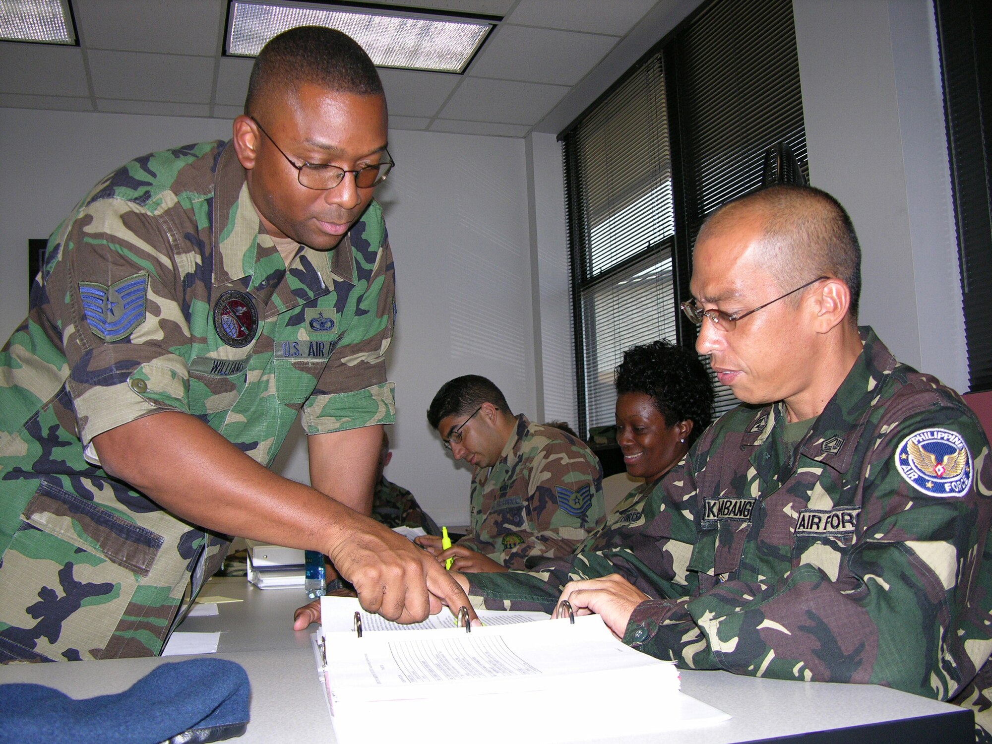 MAXWELL AIR FORCE BASE, Ala. (AETCNS) -- Tech. Sgt. Curtis Williams, Gunter NCO Academy instructor, points out information to the academy’s first international student, Tech Sgt. Virgilio Macasaet Katimbang of the Philippine air force. Sergeant Katimbang will graduate the academy Sept. 15 and return to an instructor job at the Philippine air force NCO School. (U.S. Air Force photo by Photo by Carl Bergquist)