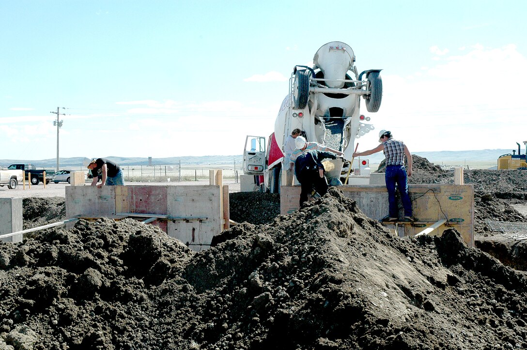 ELLSWORTH AIR FORCE BASE, S.D., Contractors pour concrete at Ellsworth's propane air mix plant Sept. 29 in preparation for the installation of four new tanks, each capable of holding 60,000 gallons of propane. The plant, completed in December 1998, was part of the first contract partnership between Ellsworth and Montana Dakota Utilities (a subsidiary of Montana Dakota Resources Inc.) and still saves Ellsworth more than $1 million annually. Contracts like these are part of why the 28th Civil Engineer Squadron Energy Management Team was recognized in the small-group category Oct. 5 during the 2006 Federal Energy and Water Management Awards ceremony in Washington. (U.S. Air Force photo/Airman 1st Class Kimberly Limrick)