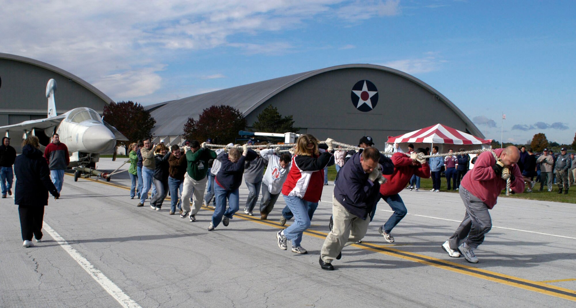A team begins to pull a 60,000 pound EF-111 Raven during the 2006 CFC Aircraft Pull Oct. 12 at the National Museum of the U.S. Air Force at Wright-Patterson Air Force Base, Ohio.  Teams pull the aircraft as far as they can in 45 seconds.  The team pulling the aircraft the greatest distance is the winner.  Team entry fees are donated to the CFC.  (U.S. Air Force photo)