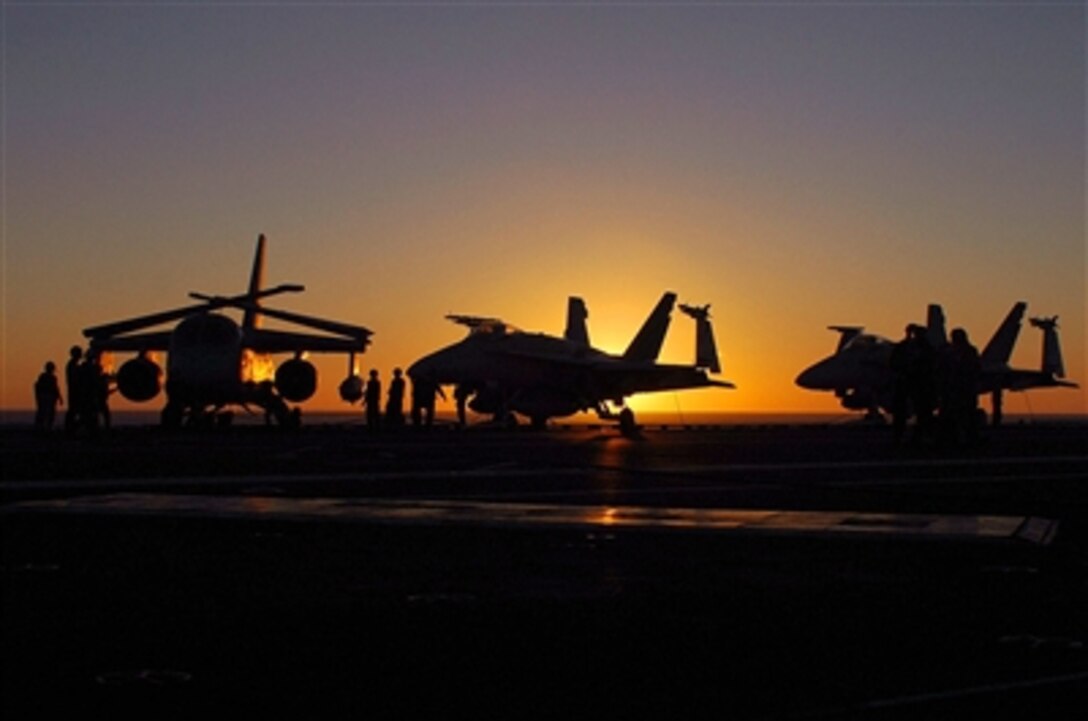 The sun sets over the flight deck of the nuclear-powered aircraft carrier USS John C. Stennis after flight operations, Oct. 2, 2006. The Stennis and embarked Carrier Air Wing 9 are Composite Training Unit Exercise off the coast of Southern California. 