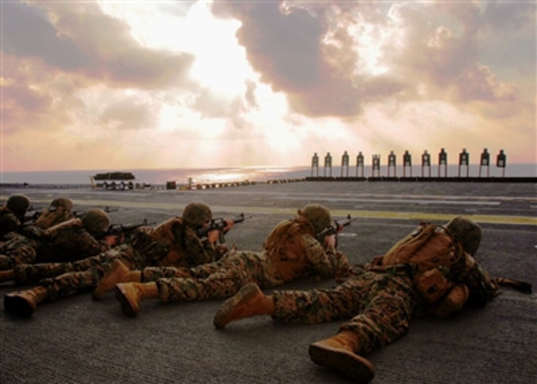 Marines of the 31st Marine Expeditionary Unit's ground combat element fire their M-16 A2 service rifles on the flight deck of the USS Essex, Oct. 14, 2006. 