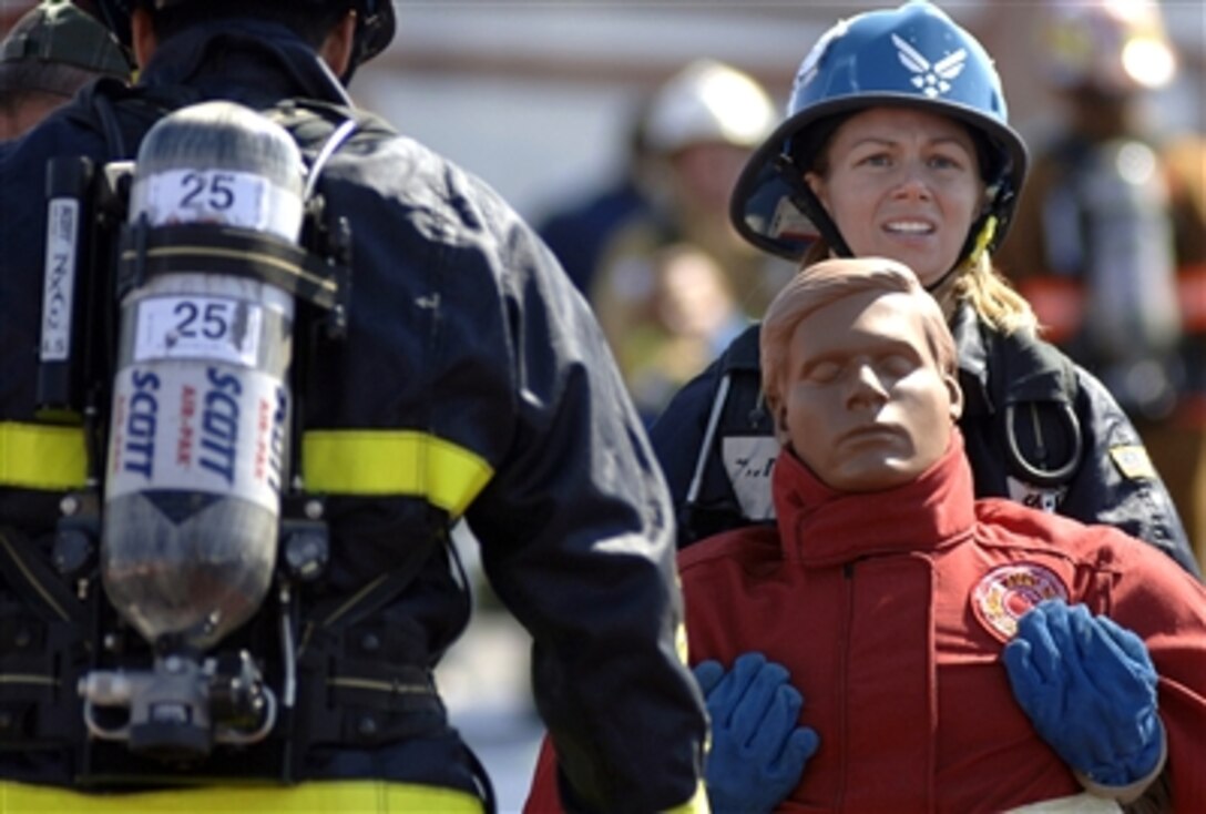Shenah Groom, Team Travis, carries a 175-pound dummy to the finish line of the tandem portion of the Firefighter Combat Competition at Morrow, Ga., Oct. 13, 2006. The event is a national competition. 