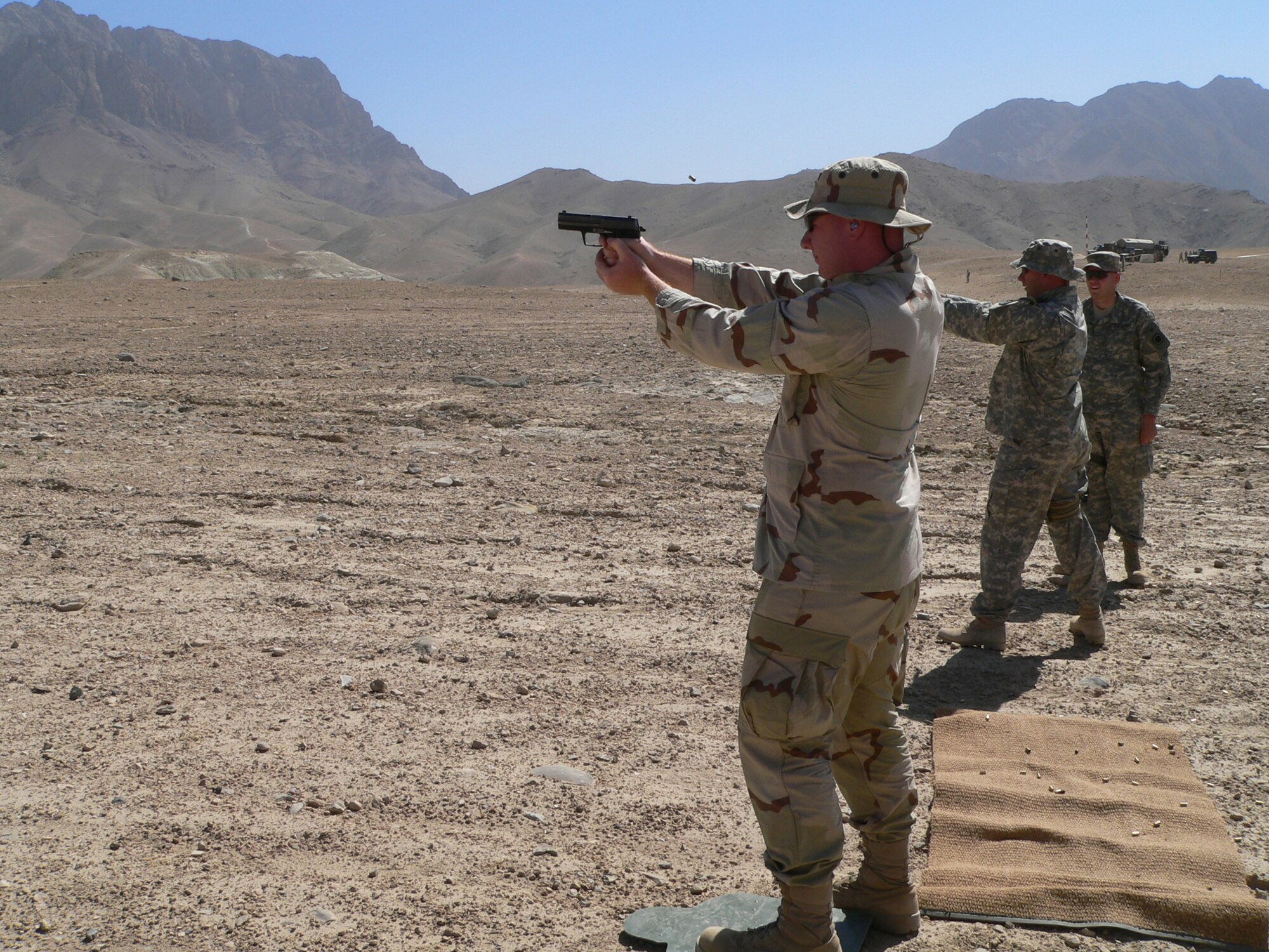 While temporarily stationed in Afghanistan, Capt. Ted Janicki, 716th Communication Flight,  qualifies with a German HK 9mm pistol.