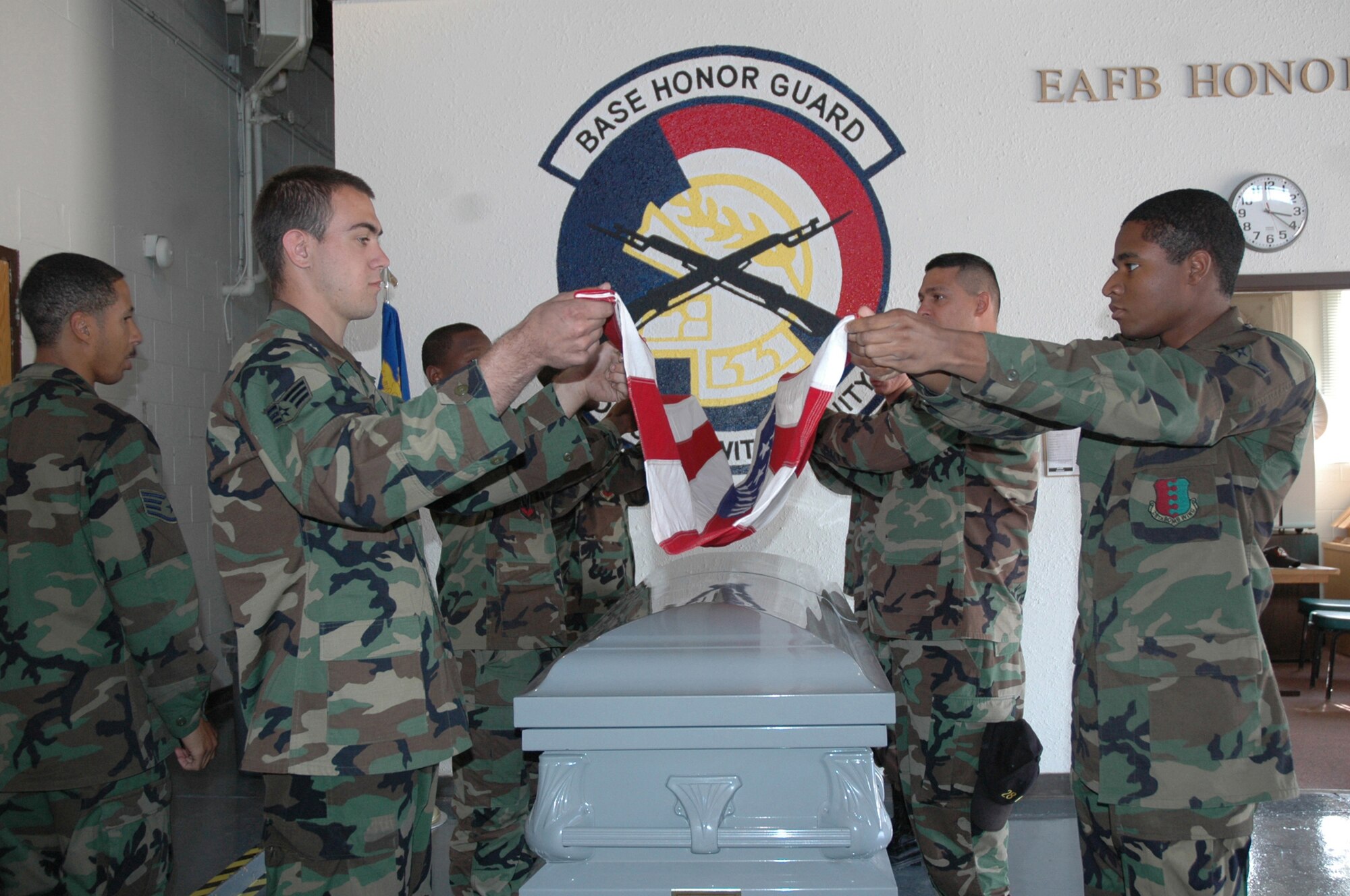 Ellsworth Honor Guard members practice to perfect ceremonial flag folding they will perform during funeral services. 