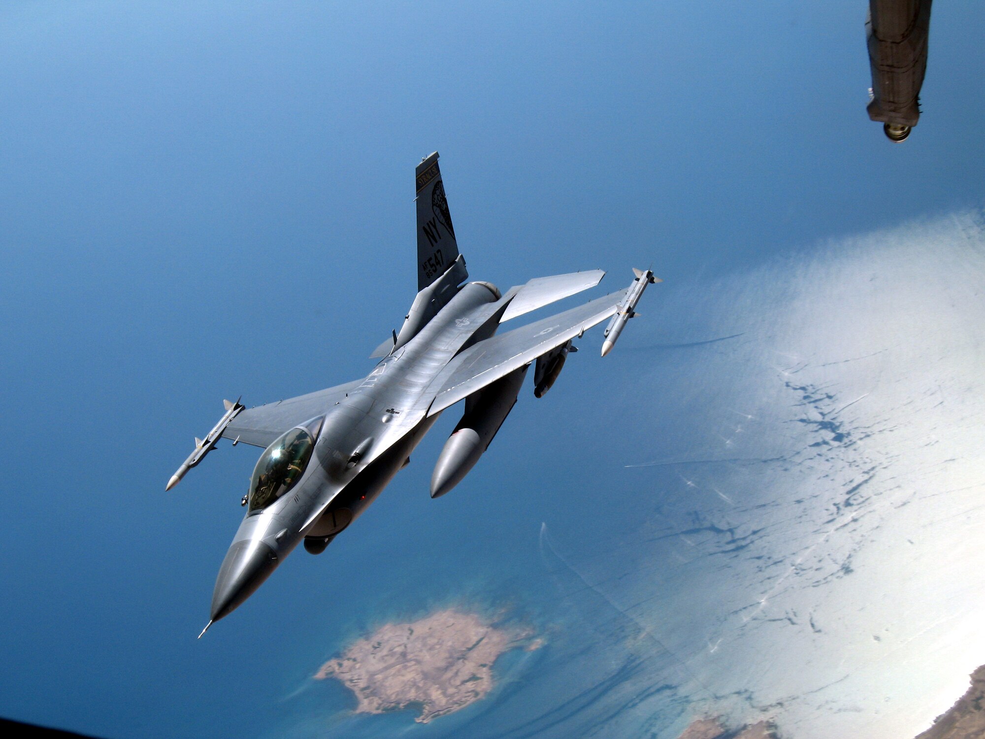 A New York Air National Guard F-16 Fighting Falcon peels off after receiving fuel from a KC-10 Extender Oct. 17 over Southwest Asia. Aircraft from the 908th Expeditionary Air Refueling Squadron, including the KC-10 and KC-135 Stratotanker, provide fuel for coalition aircraft missions for Operations Iraqi Freedom and Enduring Freedom. The squadron is attached to the 380th Air Expeditionary Wing, the largest air refueling wing in Southwest Asia. (U.S. Air Force photo/Senior Airman Matt Craig) 
