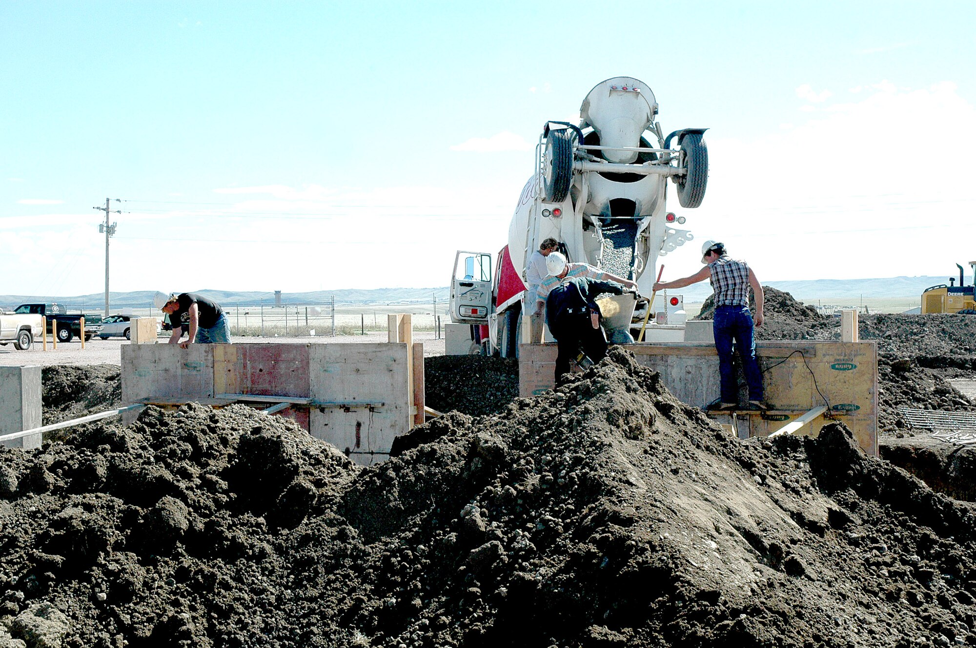 Contractors pour concrete at the propane air mix plant in preparation for the installation of four new tanks, each capable of holding 60,000 gallons of propane, Sept. 29 at Ellsworth Air Force Base, S.D. The 28th Civil Engineer Squadron Energy Management Team at Ellsworth AFB received a 2006 Federal Energy and Water Management Award from the U.S. Department of Energy for saving more than $470,000 in total energy costs for fiscal 2005. The plant, completed in December 1998, was part of the first contract partnership between Ellsworth AFB and Montana Dakota Utilities and still saves Ellsworth more than $1 million annually. (U.S. Air Force photo/Airman 1st Class Kimberly Limrick)