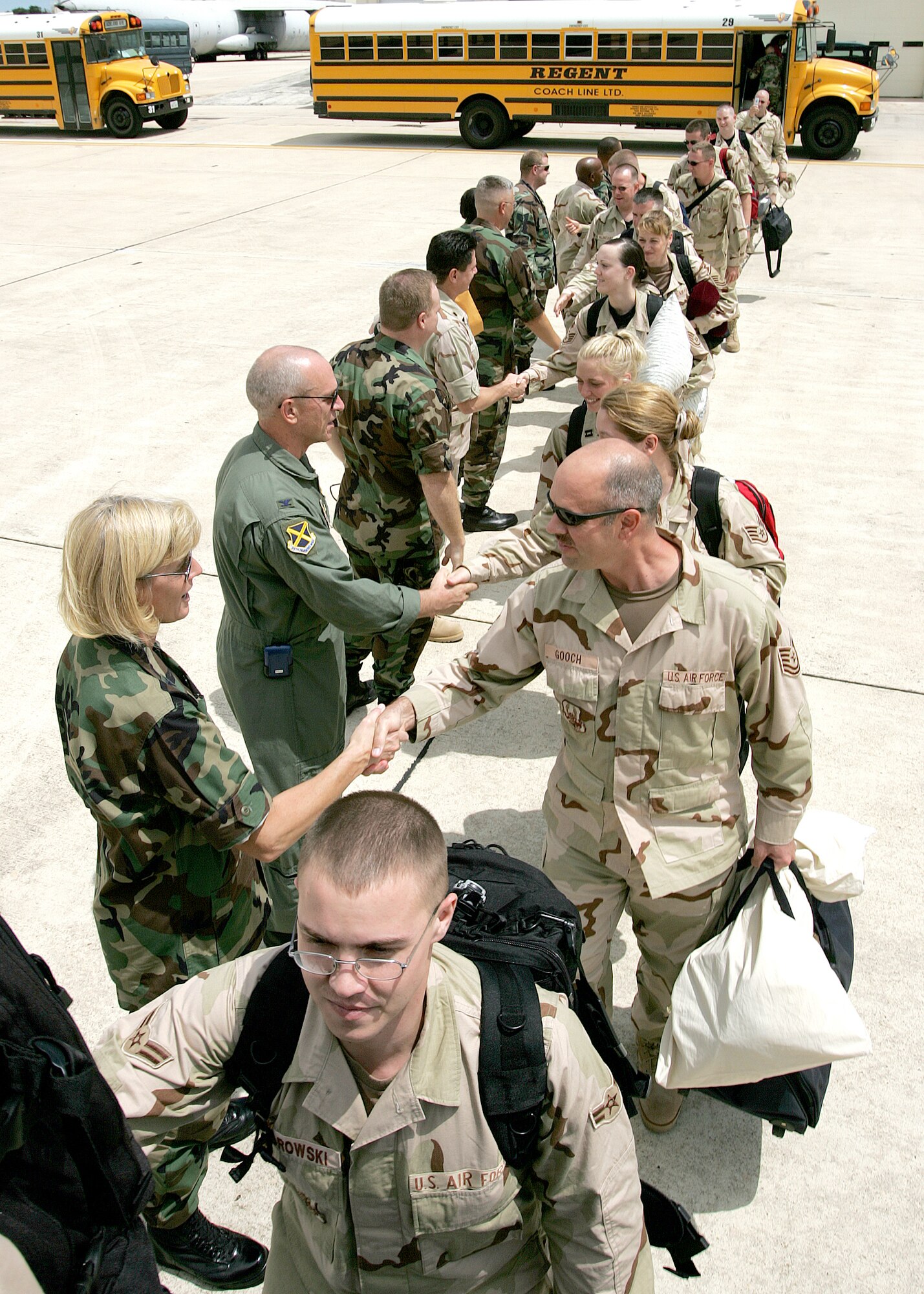 Leaders from the 37th Training Wing at Lackland Air Force Base, Texas, wish Airmen good luck as they board a flight Aug. 28 at Kelly Field. Lackland’s Deployment Processing Center and Kelly Field personnel have been busy the past few days and will remain busy for a couple more weeks as more than 1,800 Airmen from 35 bases are aggregating here and deploying to the U.S. Central Command’s area of responsibility. Lackland recently was designated as the U.S. Western Hub for Air Expeditionary Forces 7 and 8 deployments. (Photo by Robbin Cresswell)