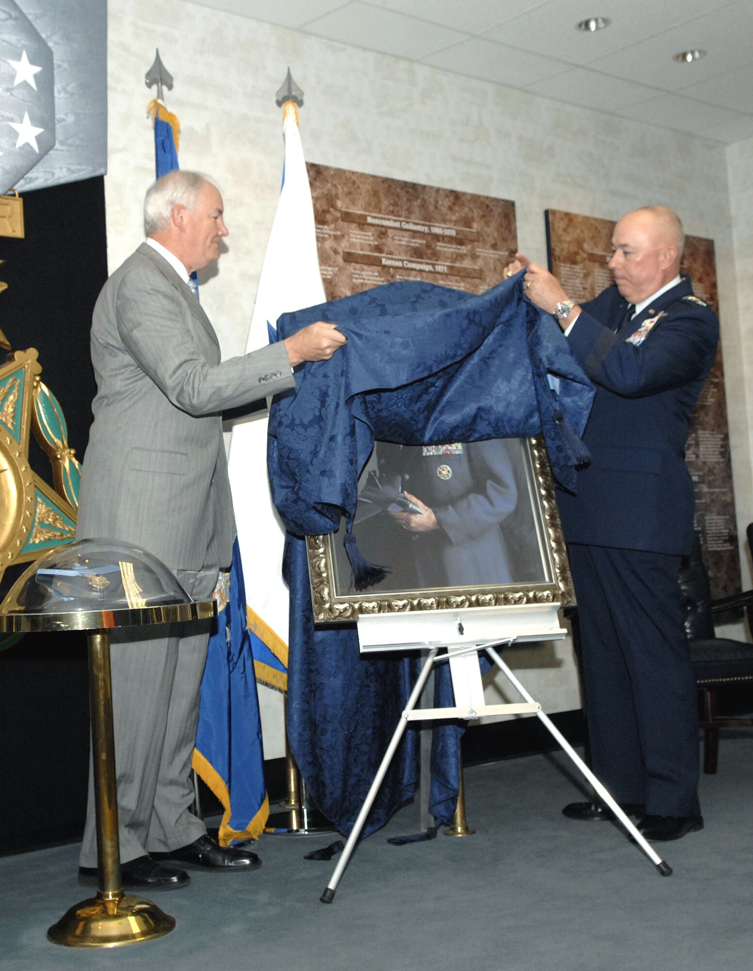 The painting of the Air Force's 17th chief of staff, Gen. John P. Jumper, is unveiled in the Hall of Heroes at the Pentagon by Secretary of the Air Force Michael W. Wynne and Air Force Chief of Staff T. Michael Mosely on Oct. 16. (U.S. Air Force photo/Tech. Sgt. Cohen Young)