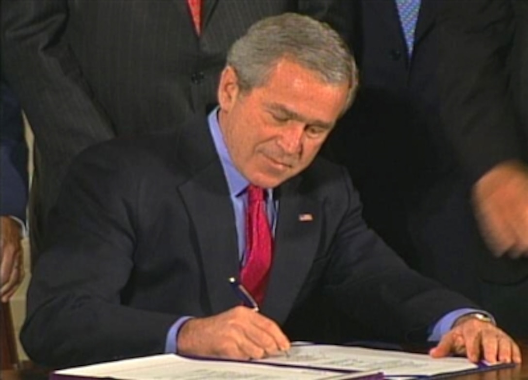 President George W. Bush signs the Military Commissions Act of 2006 during White House ceremonies today. The act enables the president to establish military commissions.
