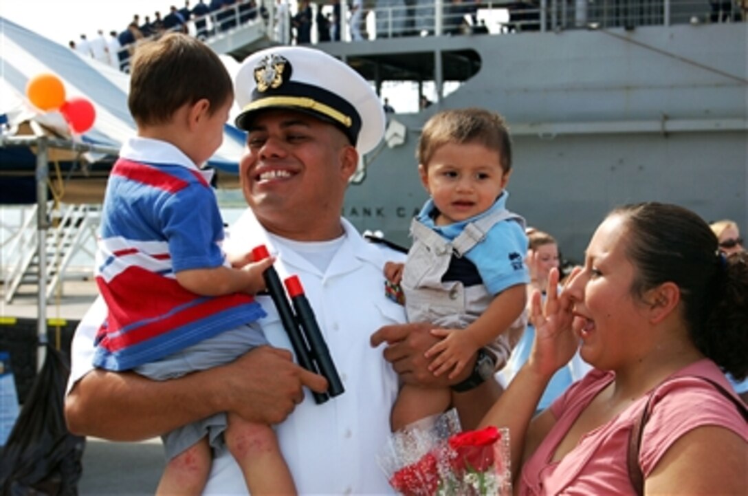 U.S. Navy Lt. Isaias Garcia greets his family during the homecoming celebration for the submarine tender USS Frank Cable (AS 40) in Apra Harbor, Guam, on Oct. 13, 2006.  The ship returned to its homeport after a five-week underway period that included visits to Malaysia, Singapore and Hong Kong.  