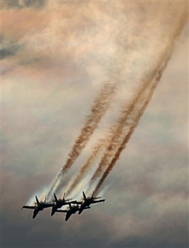 Water vapor trails from the wings of the Blue Angels' F/A-18 Hornet aircraft as they pull out of a diving maneuver during their air show performance at Marine Corps Air Station Miramar, Calif., on Oct. 13, 2006.  The show celebrated the U.S. Navy Flight Demonstration Squadronís 60th anniversary.  