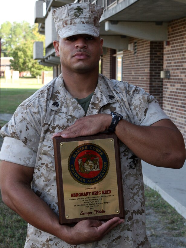 MARINE CORPS BASE CAMP LEJEUNE, N.C. (Oct. 15, 2007) ? Sgt. Eric W. Reid displays an award that was presented to him by The Marine Corps Engineer Association during its 15th annual reunion, here Oct. 18.  Reid was awarded the Bulk Fuel Noncommissioned Officer of the Year Award for outstanding performance of duties while deployed to Iraq with 8th Engineer Support Battalion.  Sgt. Timothy Liners, who requested to not be photographed, was awarded the Combat Engineer NCO of the Year Award.  Reid is a bulk fuel specialist and Liners is a combat engineer, both from 8th ESB. (Official U.S. Marine Corps Photo by: Pfc. Bobbie A. Curtis)