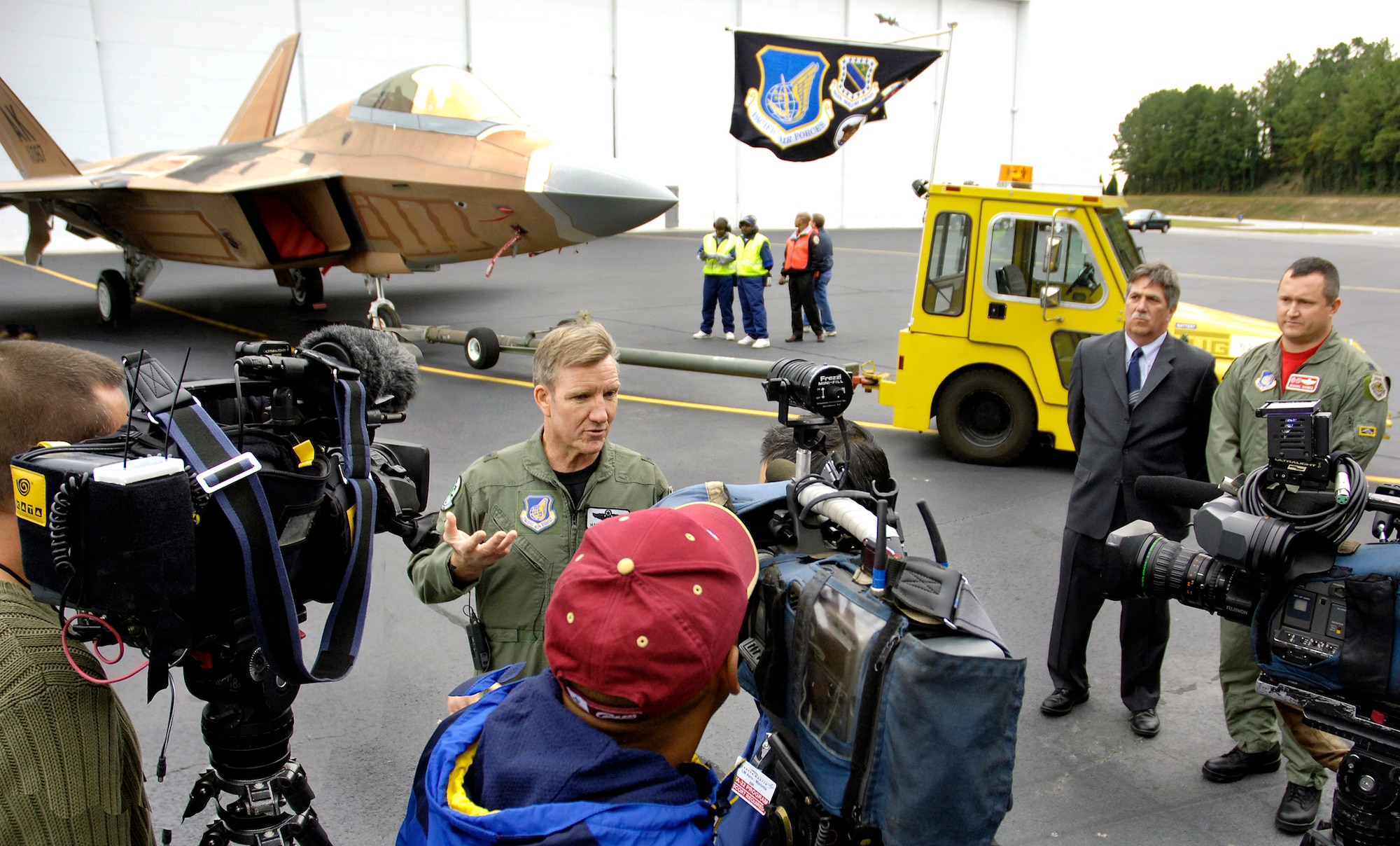 Brig. Gen. Herbert Carlisle, commander of the 3rd Wing at Elmendorf Air Force Base, Alaska, is interviewed after the roll-out of the Pacific's first combat ready F-22, destined for Elmendorf AFB.  The F-22 dominates any adversary through unmatched performance achieved through stealth, supercruise speed, agility, precision and a complete view of the battlespace achieved with the advanced sensor suite embedded in the aircraft.  (Photo by John Rossino)