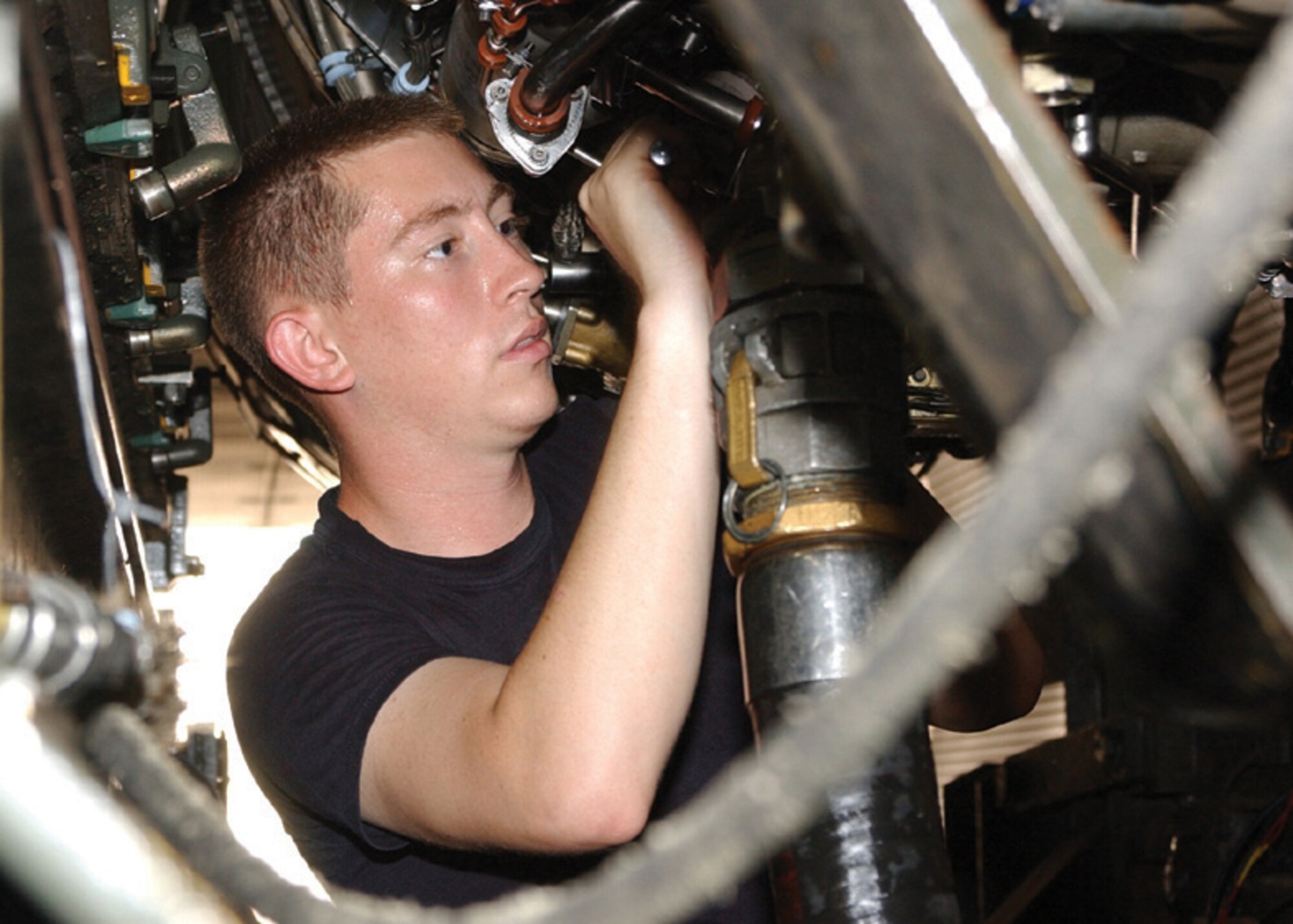 Senior Airman Joshua Spainhoward, 325th Maintenance Squadron propulsion flight jet engine mechanic at Tyndall Air Force Base, Fla., makes final test equipment connections prior to an engine maintenance test run inside Hush House No. 1. (U.S. Air Force photo by Tech. Sgt. Dan Neely)