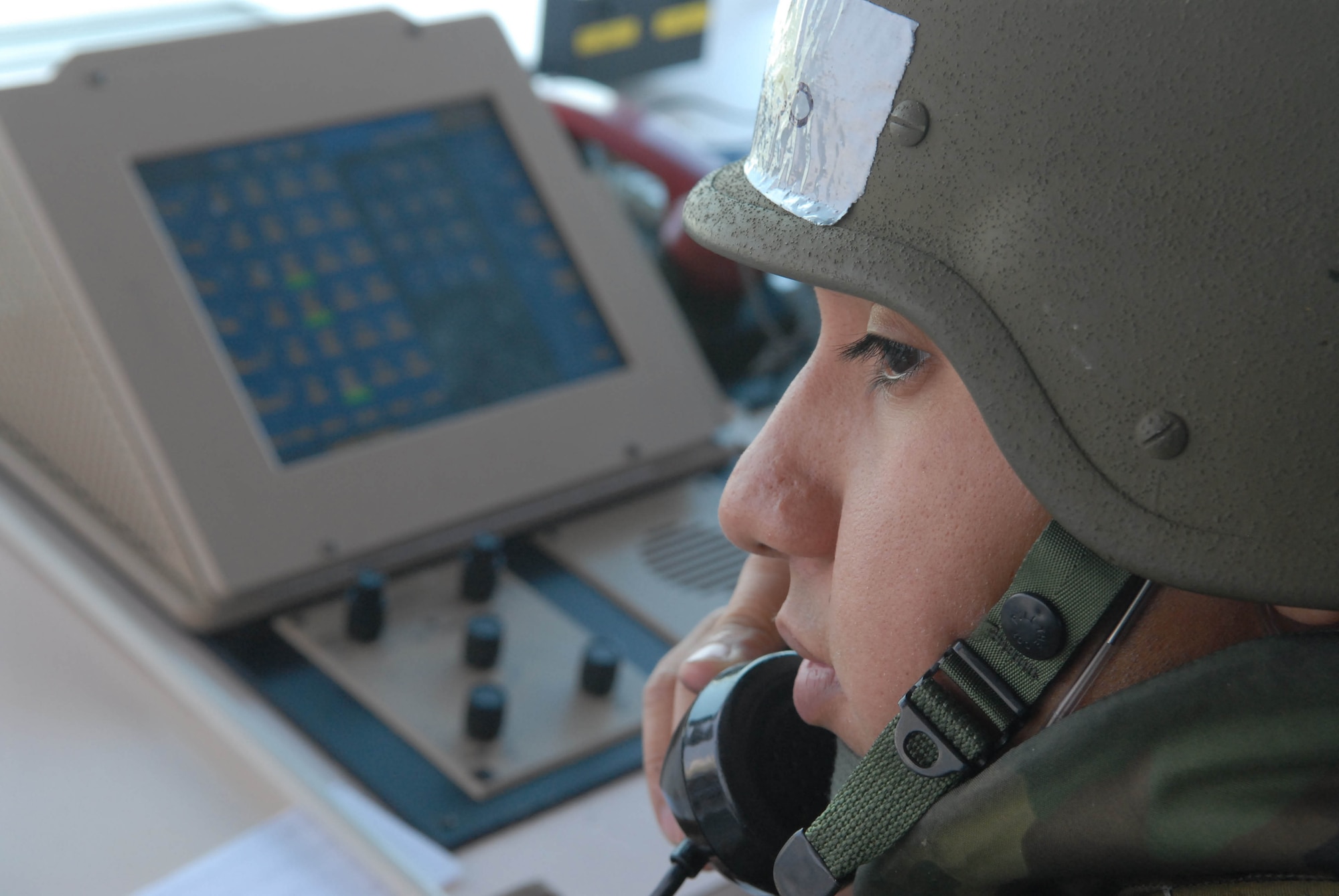 Staff Sgt. Oscar Alvarado makes a call on the crash phone in the air traffic control tower during an exercise Oct. 17 at Kadena Air Base, Japan. The crash phone is used to rapidly notify all base emergency services in the event of an aircraft mishap. The 18th Wing exercise from Oct. 13 to 19 tests the wing's ability to respond to a wartime situation. Sergeant Alvardo is assigned to the 18th Operations Squadron. (U.S. Air Force photo/Tech. Sgt. Dave DeRemer)
