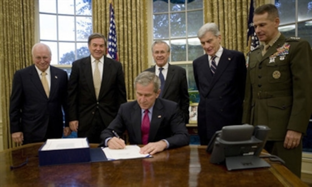 President Bush signs into law the John Warner National Defense Authorization Act for Fiscal Year 2007, Oct. 17, 2006, in the Oval Office. Joining him are  Vice President Dick Cheney, Rep. Duncan Hunter of California, Defense Secretary Donald Rumsfeld, Sen. John Warner of Virginia, and Chairman of the Joint Chiefs of Staff  Gen. Peter Pace.