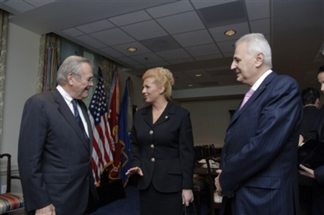 Secretary of Defense Donald H. Rumsfeld (left) welcomes Croatian Minister of Foreign Affairs Kolinda Grabar-Kitarovic (center) and Minister of Culture Bozo Biskupic (right) to the Pentagon on Oct. 17, 2006.  Grabar-Kitarovic and Biskupic are joining Croatian Prime Minister Ivo Sanader when he meets with Rumsfeld to discuss defense issues of mutual interest.  