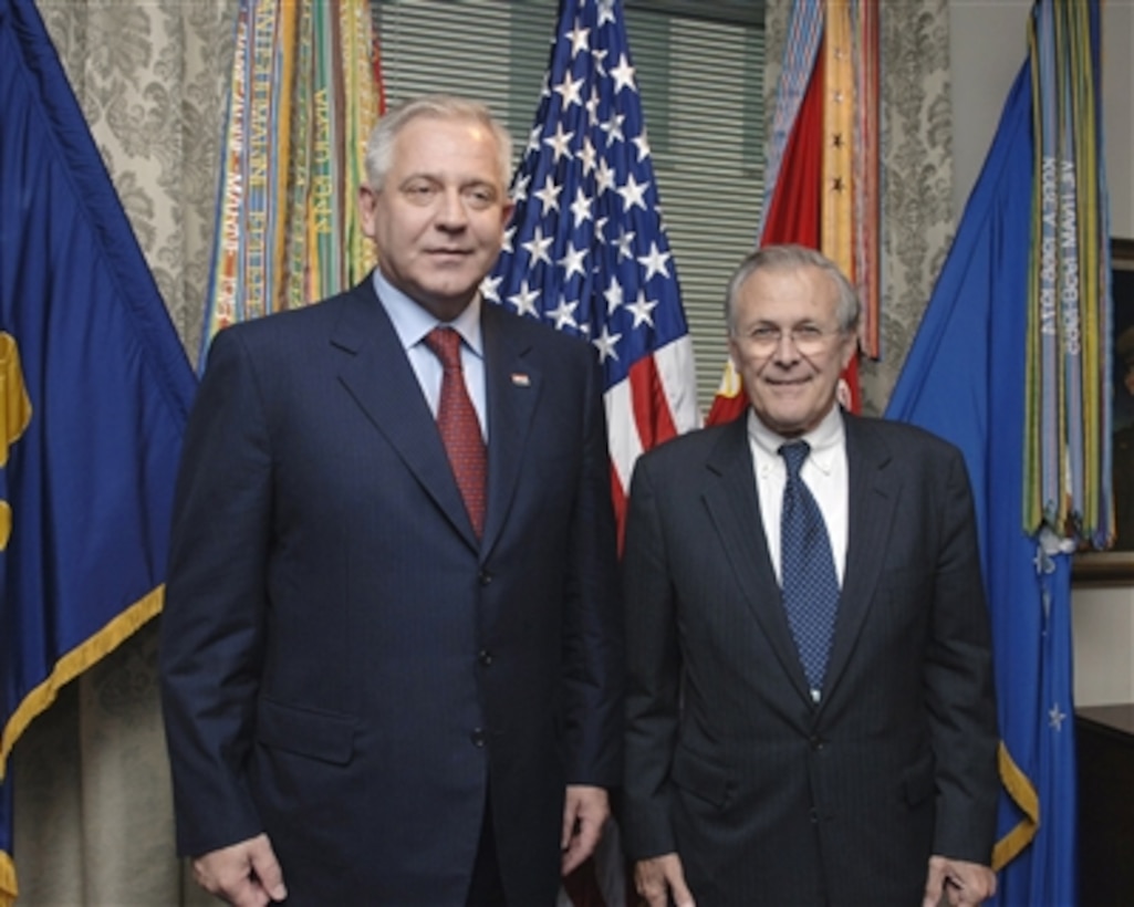 Secretary of Defense Donald H. Rumsfeld (right) and Croatian Prime Minister Ivo Sanader (left) pose for photographers prior to their meeting in the Pentagon on Oct. 17, 2006.  Rumsfeld and Sanader will meet to discuss defense issues of mutual interest.  