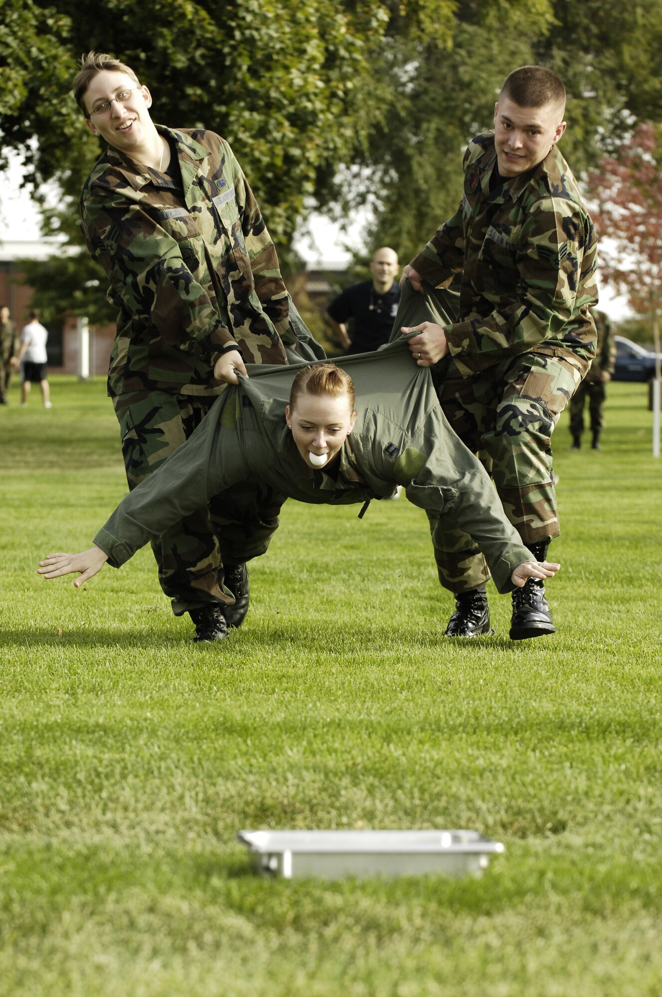 FAIRCHILD AIR FORCE BASE, Wash. -- Senior Airman Erin Hicks, a Security Forces member from the 459th Air Refueling Wing, Andrews AFB, Md., currently assigned here to attend Airman Leadership School, becomes a “Captain” during her short flight in the egg carry at the First Sergeant’s Oktoberfest hosted Oct. 6. Helping her complete the mission were Fairchild’s own, Senior Airman Kristina Furley, 92nd Logistics Readiness Squadron flight service center technician, and Senior Airman Donald O’Neil, 92nd Civil Engineering Squadron firefighter. More than 150 Airmen attended the festivities. (U.S. Air Force photo/Senior Airman Anthony Ennamorato)