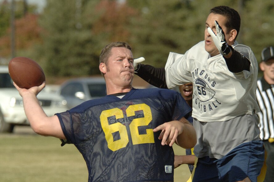 FAIRCHILD AIR FORCE BASE, Wash. -- Master Sgt. Kyle Campbell, 92nd Security Forces Squadron NCO in charge of operations support, attempts to block a pass by Mike Carr, Spokane Police Department. The 92nd SFS emerged victorious Oct. 13, defeating the team of off-base law enforcement by a score of 14-12. With no time left on the clock, the off-base cops failed to tie the game with a two-point conversion on the last play. This was the first year for a football match-up pitting Security Forces against their off-base counterparts. The idea, event organizers said, was to enhance camaraderie between the organizations and build on their already positive relationship. (U.S. Air Force photo/Senior Airman Chad Watkins)