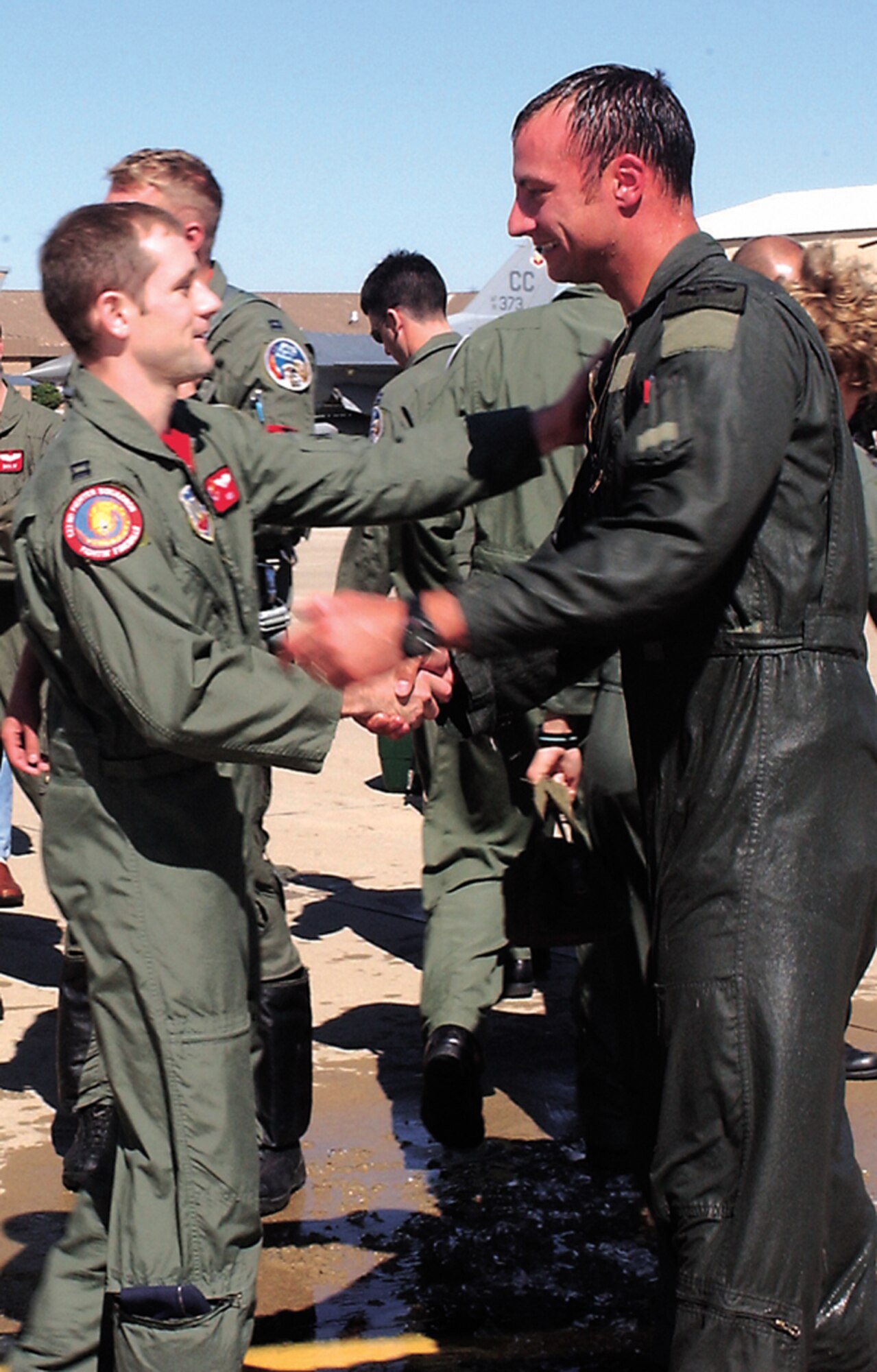 CANNON AIR FORCE BASE, N.M. -- Capt. Ryan “Rock” Wartman, left, and Capt. Steven “Amp” Frodsham, 522nd Fighter Squadron pilots, talk Oct. 13 after Captain Frodsham's fini flight – his last at Cannon. Captain Frodsham is the Air Combat Command Instructor Pilot of the Year for 2005 and is heading to Langley Air Force Base, Va. (U.S. Air Force photo/ Airman 1st Class Tiffany Curbeam)