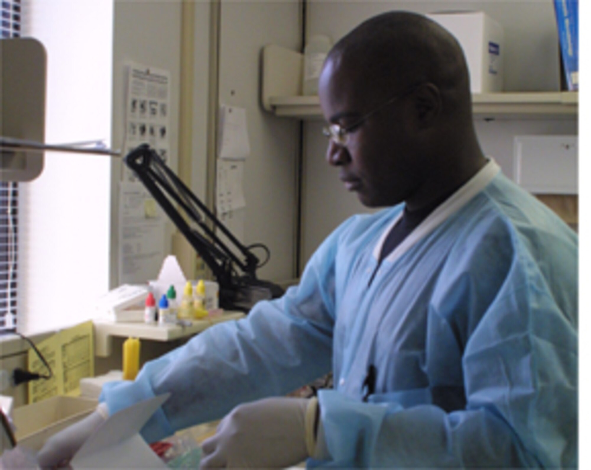 Senior Airman Carl Brown determines the results of a strep test for a patient.