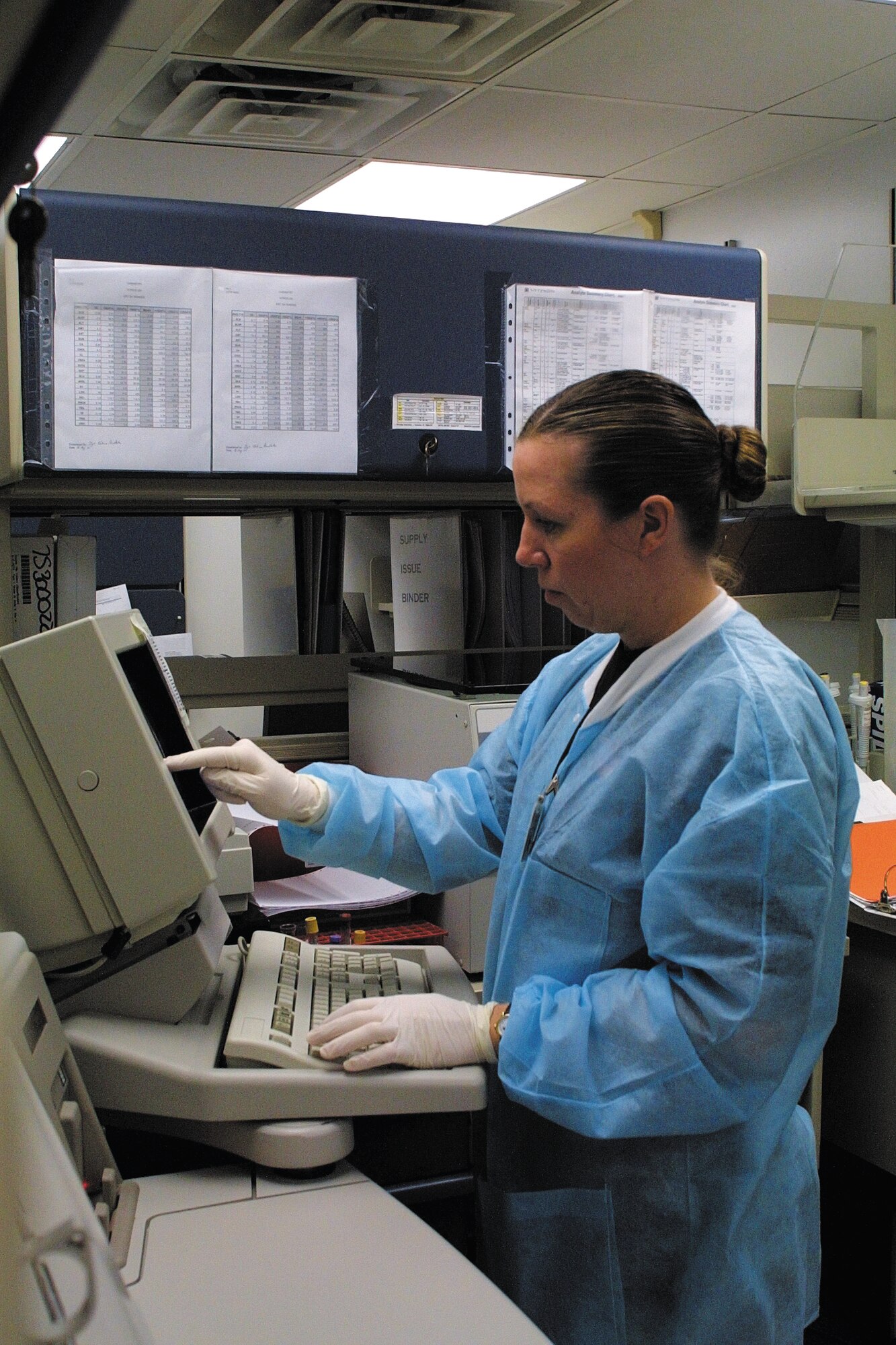 SSgt. Michelle Freysinger working in the infection control lab types in patient sample information and awaits results. (U.S. Air Force photo/Kelly Twedell)