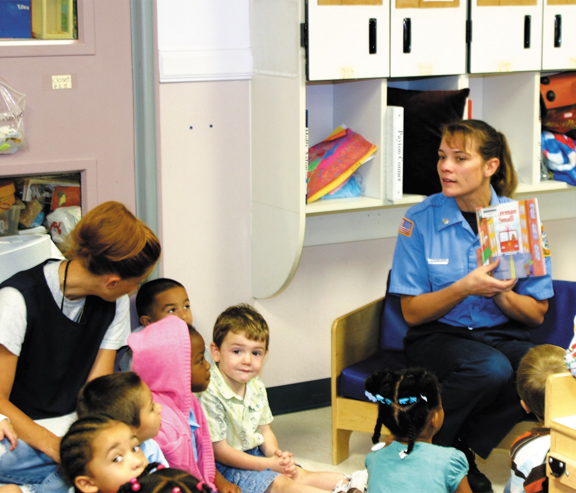 The library held its weekly story hour Oct. 12 at the Pope Child Development Center to bring awareness to Fire Prevention Week. Firefighter Angie Perrault read a library book on fire safety to the children before they toured the fire engine outside. The children practiced fire drills and were given plastic firefighter's hats, too. (U.S. Air Force photo/Kelly Twedell)