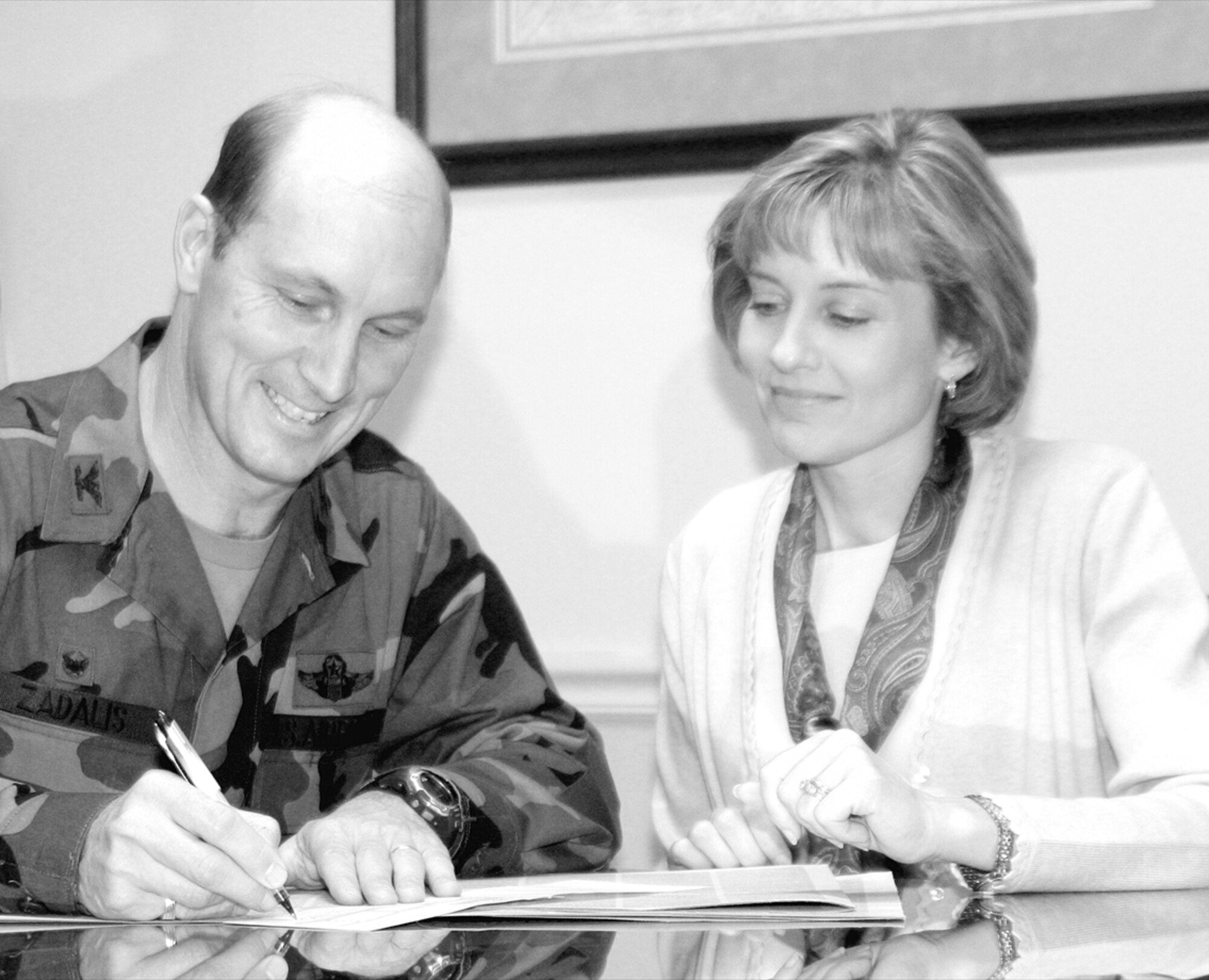 Col. Timothy Zadalis, 43rd Airlift Wing commander, and his wife, Carol, decide over which charities to donate to for the 2006 Combined Ferderal Campaign Oct. 12. The colonel and his wife decided to donate to local agencies this ear including the Airman and Family Readiness Center. (U.S. Air Force photo/ 1st Lt. Lisa Ferguson)