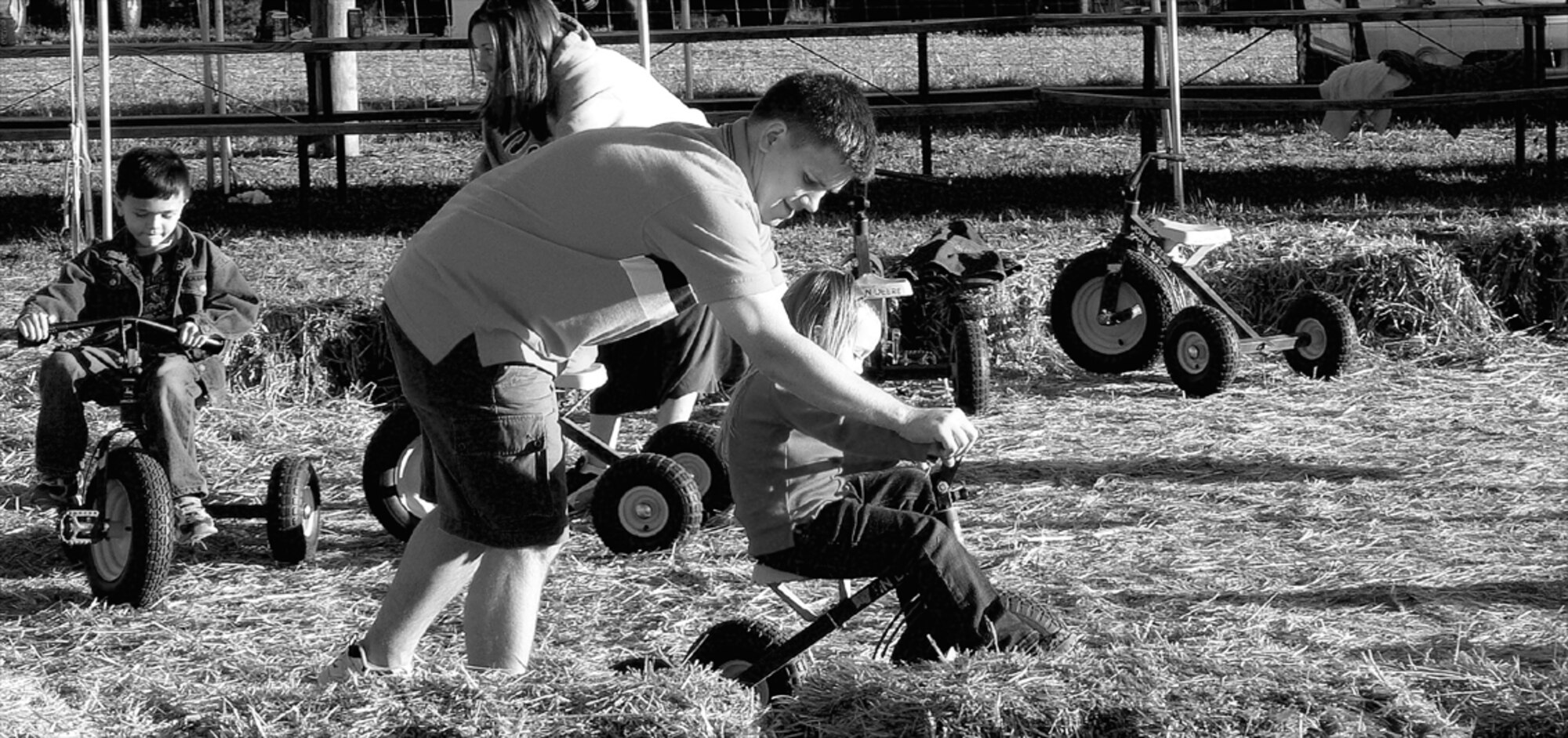 Capt. Robert Forbess, 2nd Airlift Squadron, helps his daughter Anya, 3, pedal a tricycle at the 2nd AS's family celebration Oct. 14. The 2nd AS leaves the end of October for a four-month rotation to Southwest Asia.  (Courtesy photo)