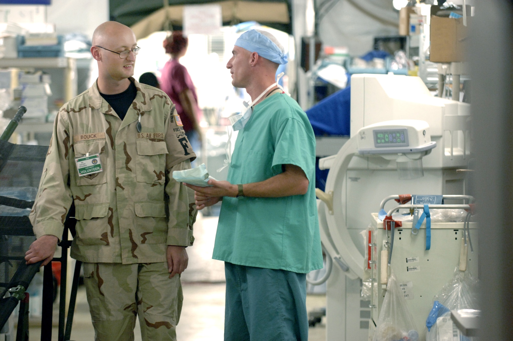 Staff Sgt. Robert Bouick (left) speaks with a fellow hospital volunteer, Army Reserve Specialist Joushua Lilliblad, at the Air Force Theatre Hospital at Balad Air Base, Iraq.  Sergeant Bouick is a force protection escort.  Specialist Lilliblad, who amassed more than 400 hours volunteering during his 365 day tour in Iraq, is cross-training from munitions to becoming a surgical technician and is spending his last duty day in theatre volunteering in the operating room during the midnight shift.  (U.S. Air Force photo/Master Sgt. Scott Wagers)