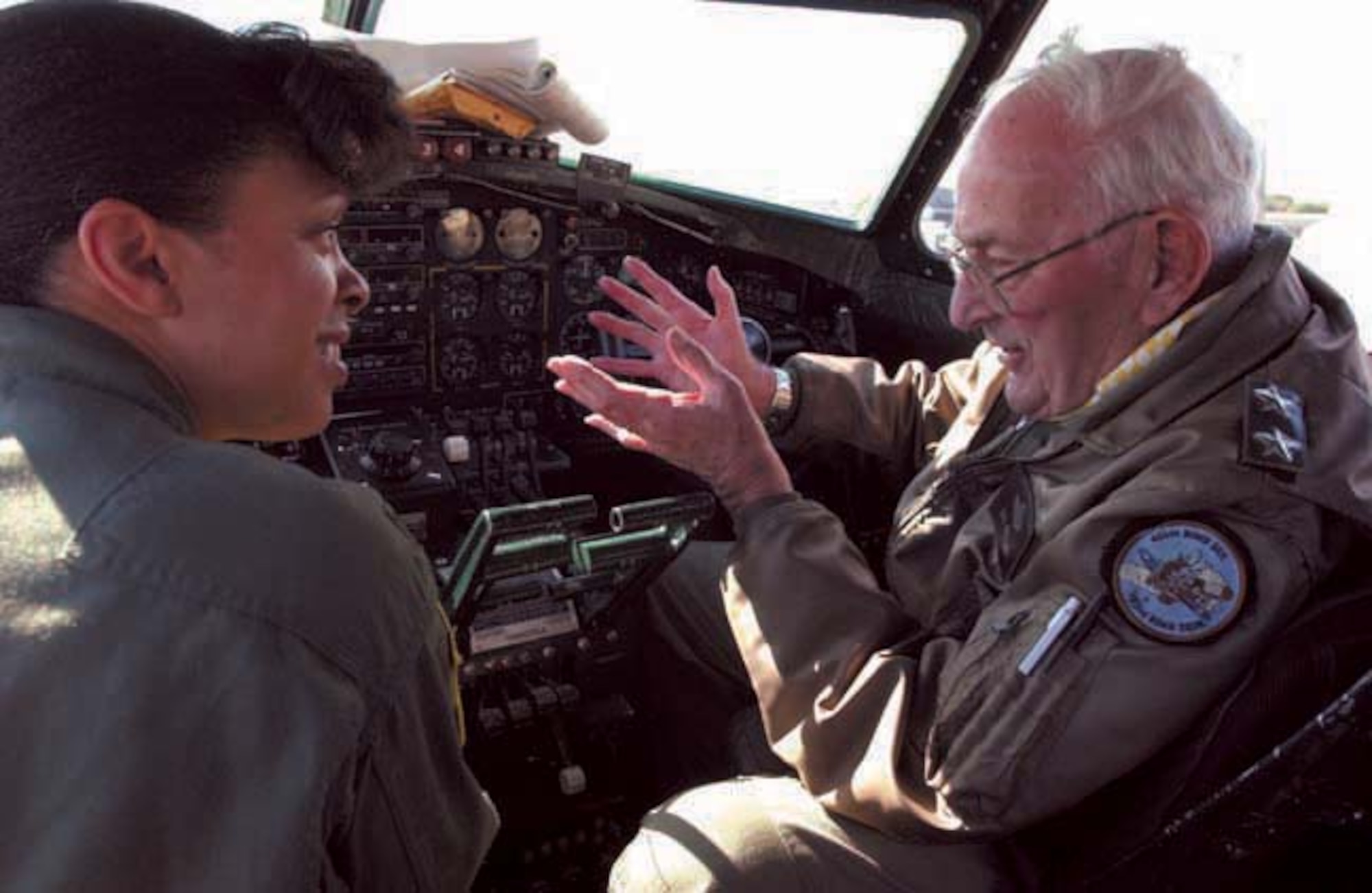 Col. Stayce D. Harris, 459th Air Refueling Wing commander, joins former Air Force Reserve Commander Maj. Gen. Richard Bodycombe, as he shares World War II stories in the cockpit of the Boeing B-17 Yankee Lady. The retired general flew the plane to Andrews Air Force Base, Md., on Oct. 12, 2006. (U.S. Air Force photo/Senior Airman Amaani Lyle)