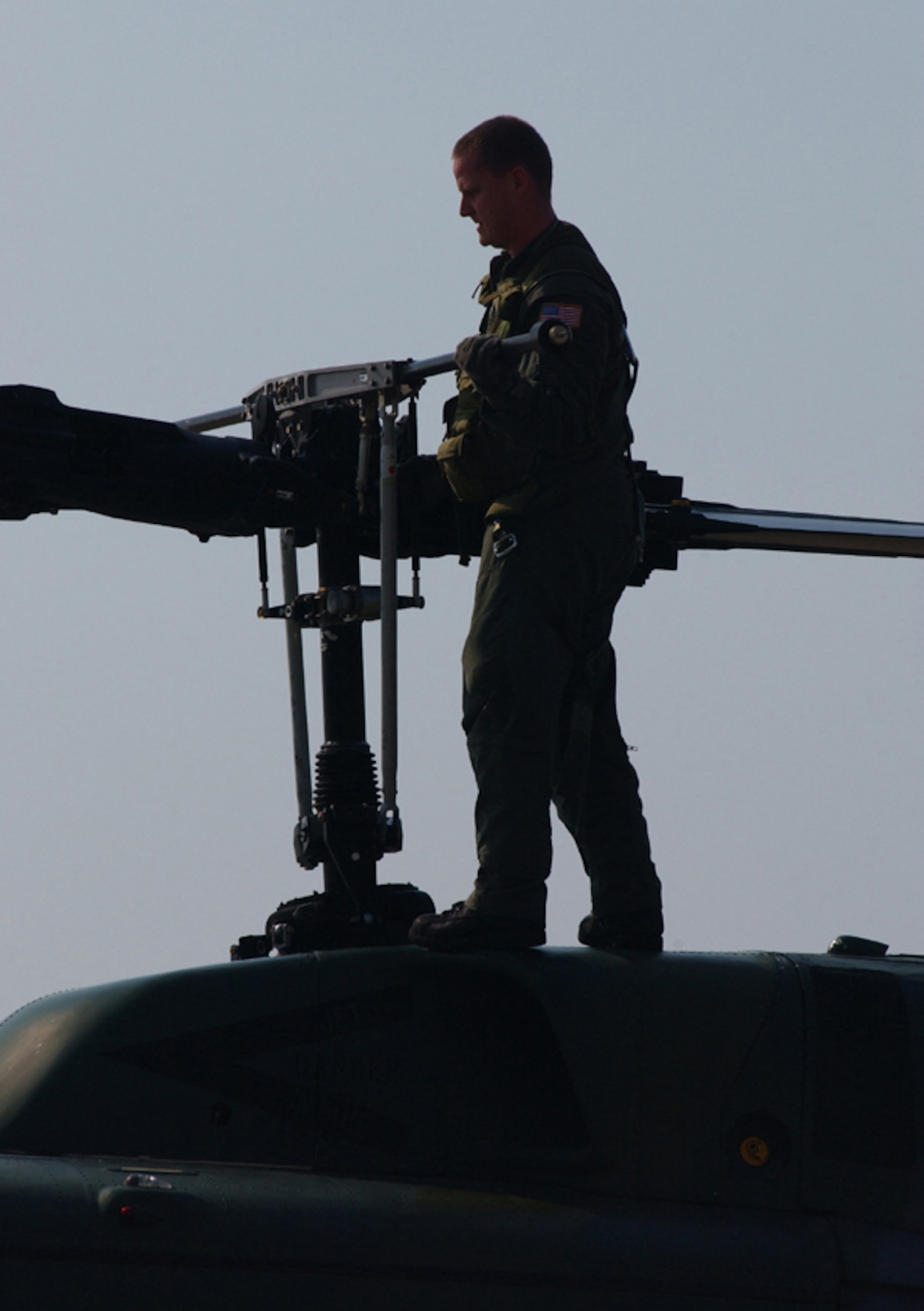 Staff Sgt. Adam Lasher, a former flight engineer for the 76th Helicopter Squadron, does a preflight check to ensure the helicopter is air worthy.